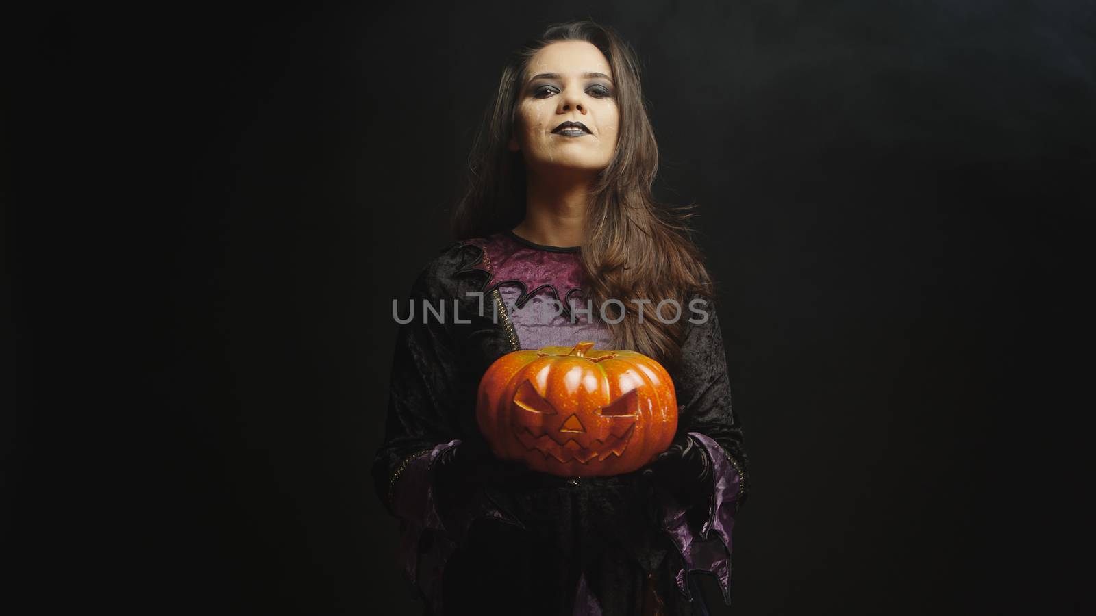 Beautiful young woman with evil face dressed up like a witch by DCStudio
