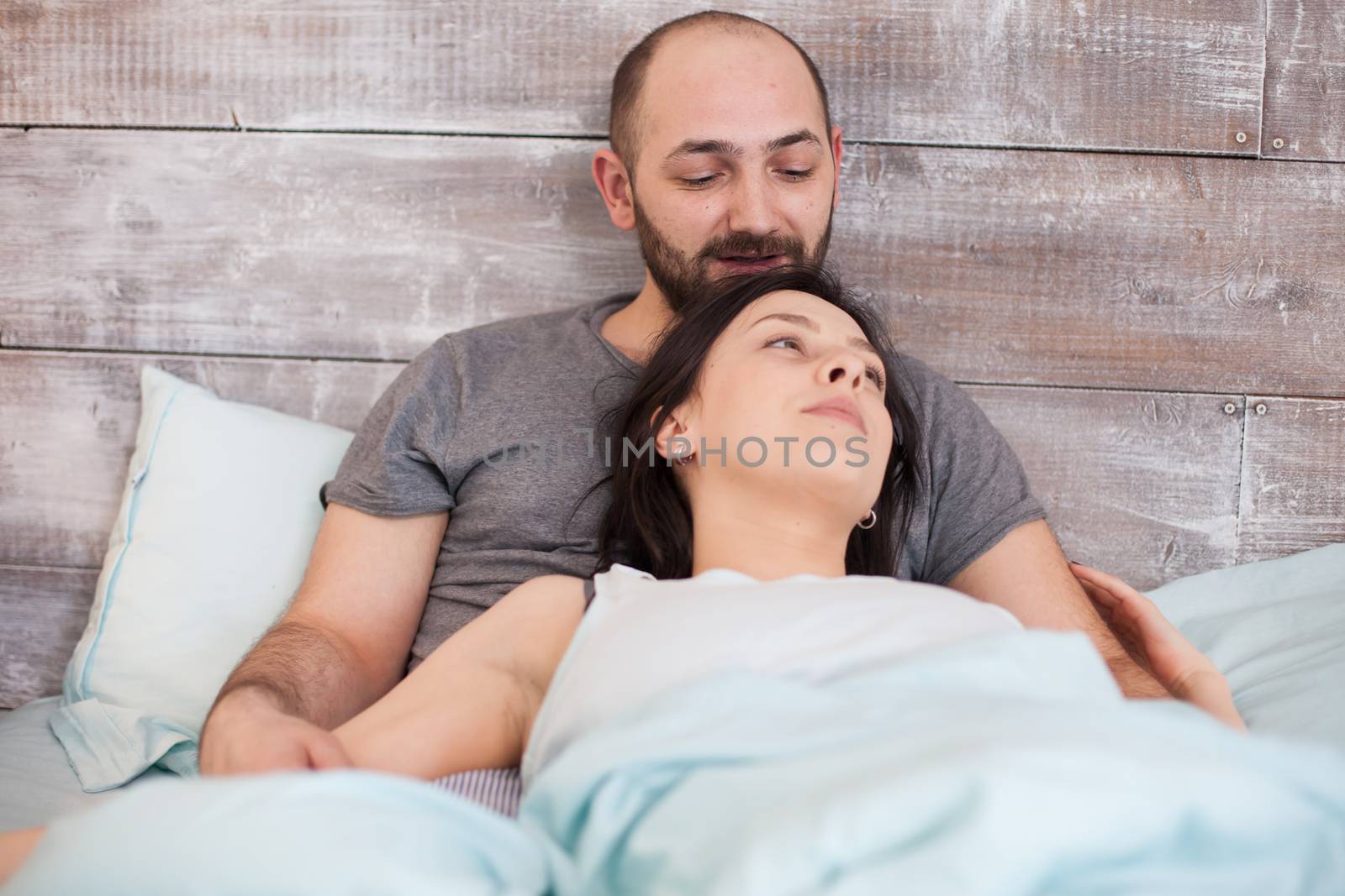 Relaxed young caucasian couple in the morning wearing pajamas.