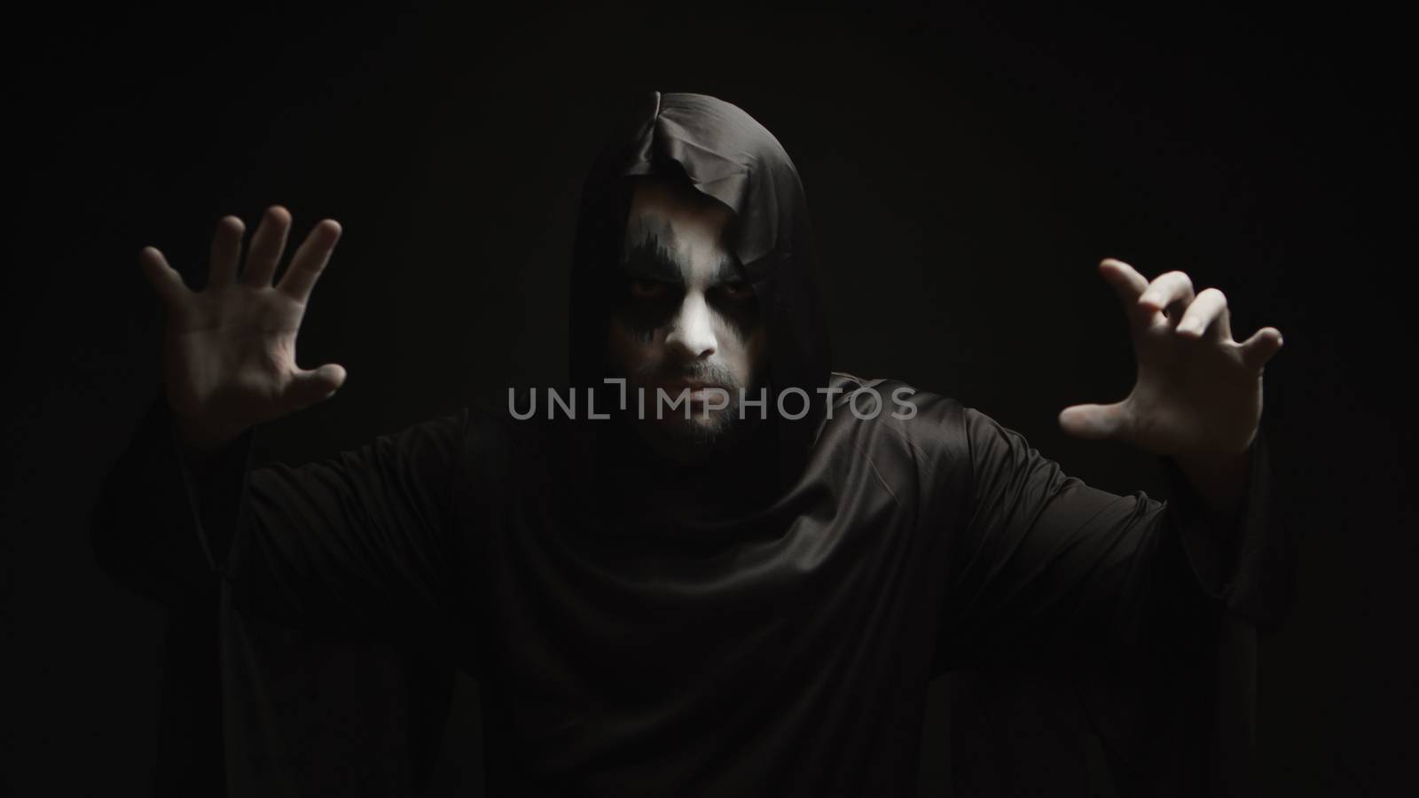 Dangerous hell demon doing magic over black background by DCStudio