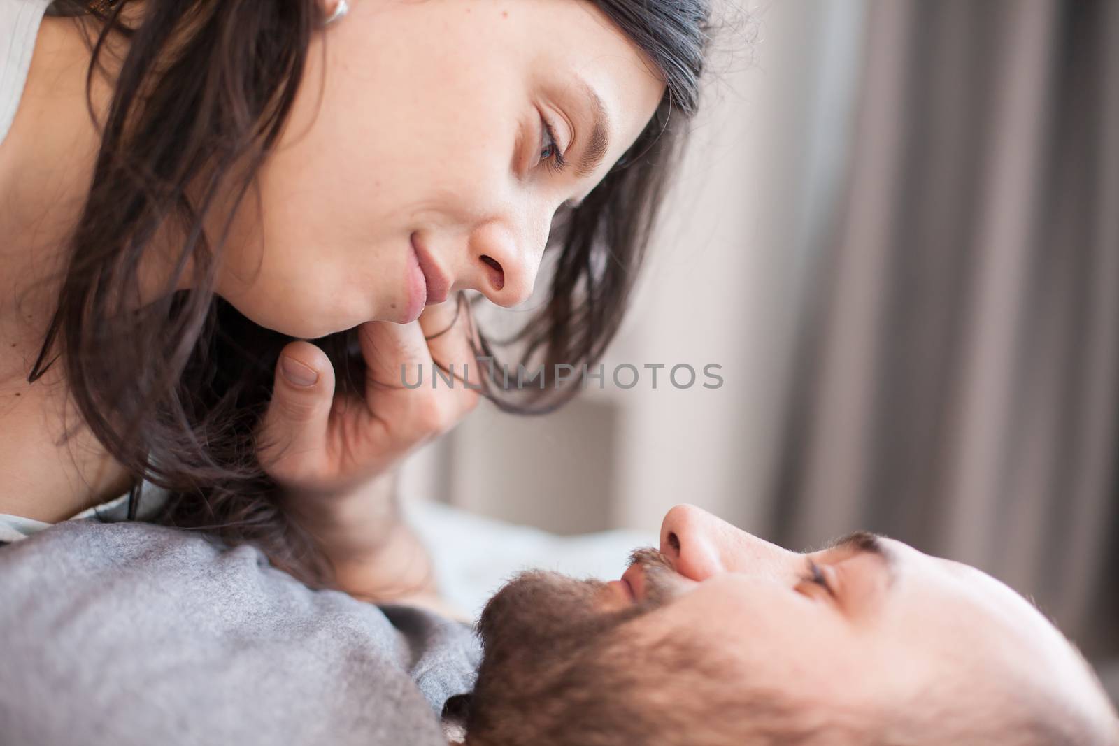 Close up of romantic couple looking at each other eyes after waking up.