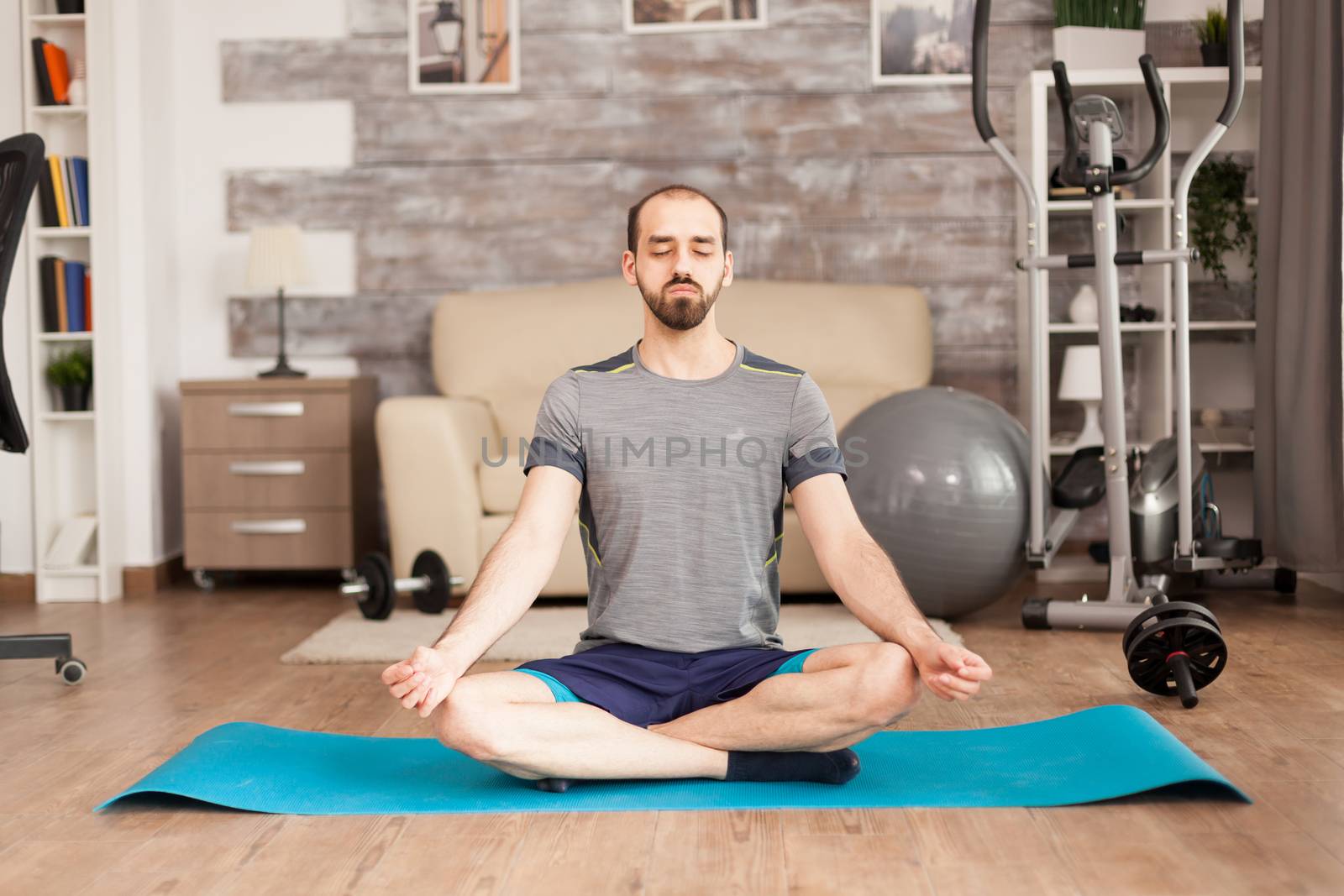 Man practicing mindfulness on yoga mat by DCStudio