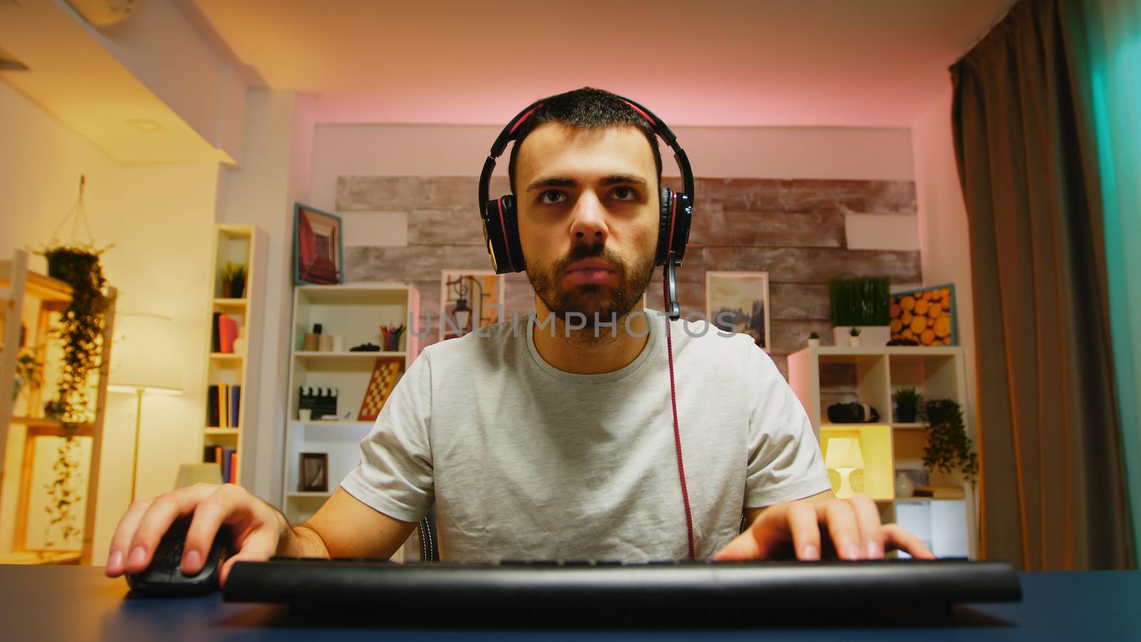 Pov of concentrated young professional gamer by DCStudio