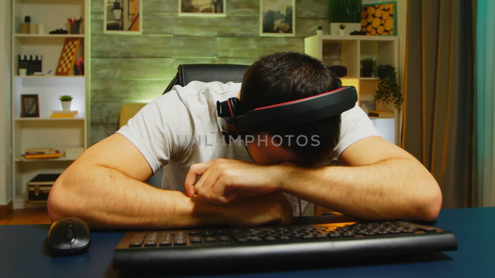 Professional gamer keeping his head on the office after losing the championship.