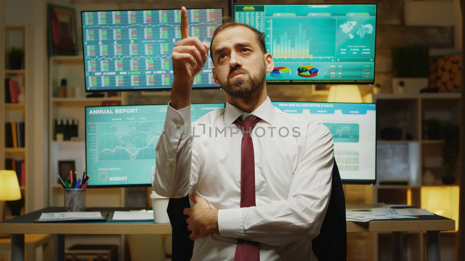 Male stock market trader pointing while using augmented reality by DCStudio