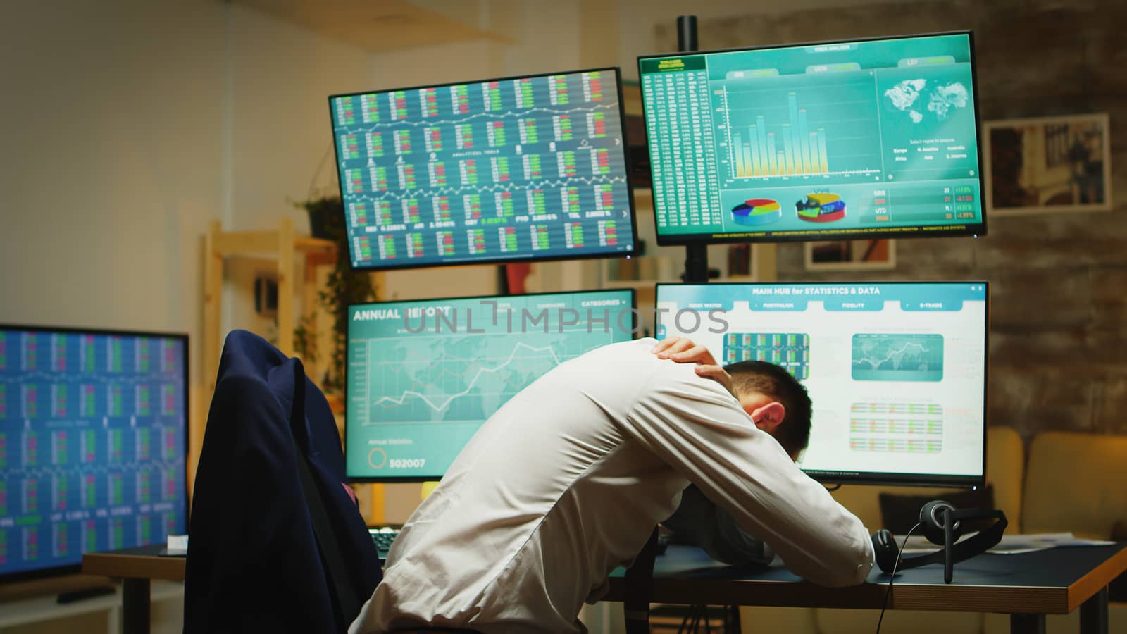 Angry stock market trader throwing graphs because of money loss in his home office with multiple displays presenting real time data of stock market