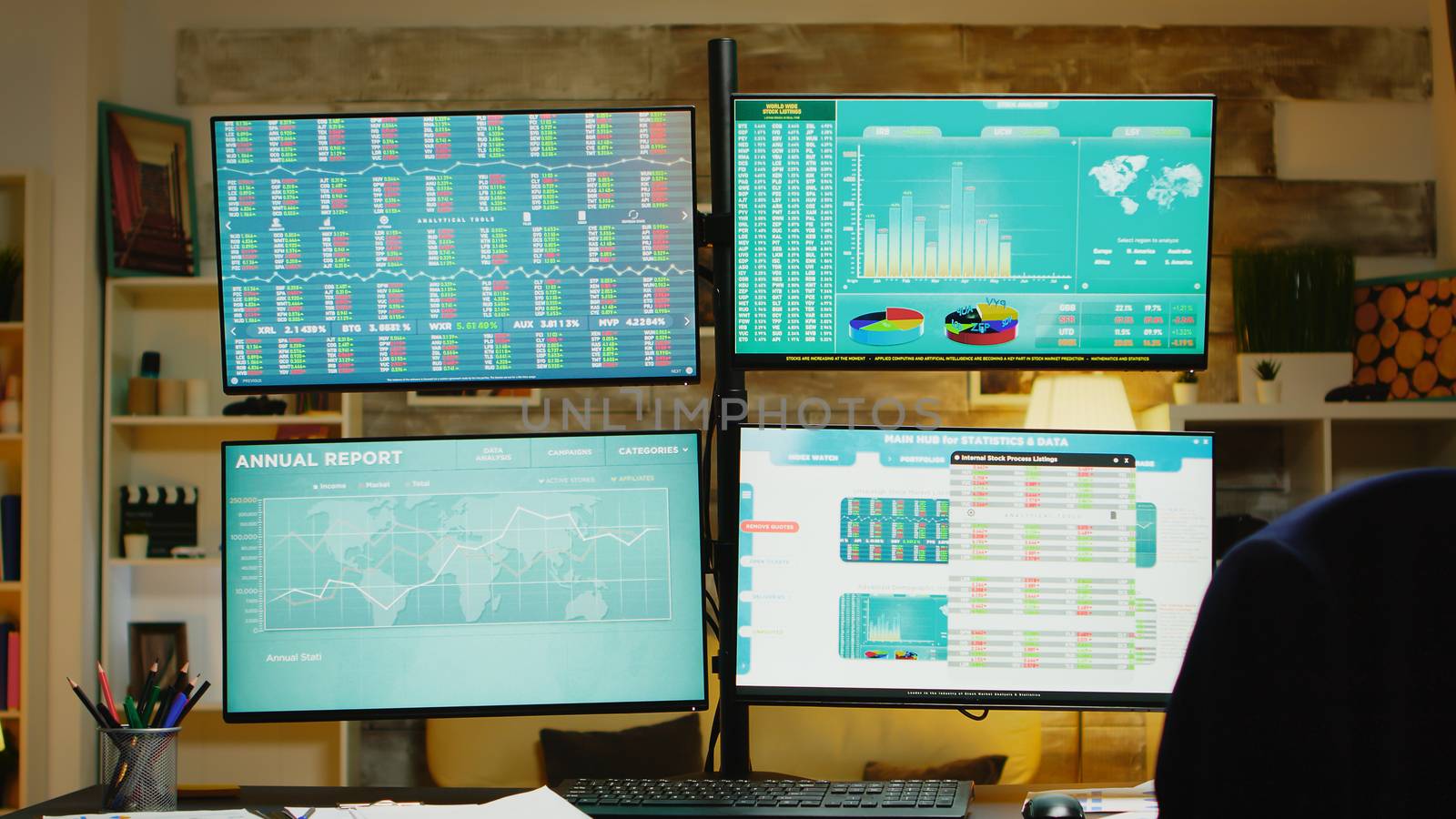 Zoom out of home office with monitors for stock market.