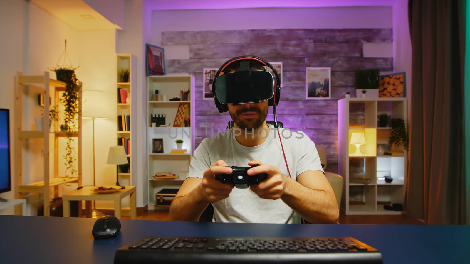 Happy young man after his victory while playing video games by DCStudio