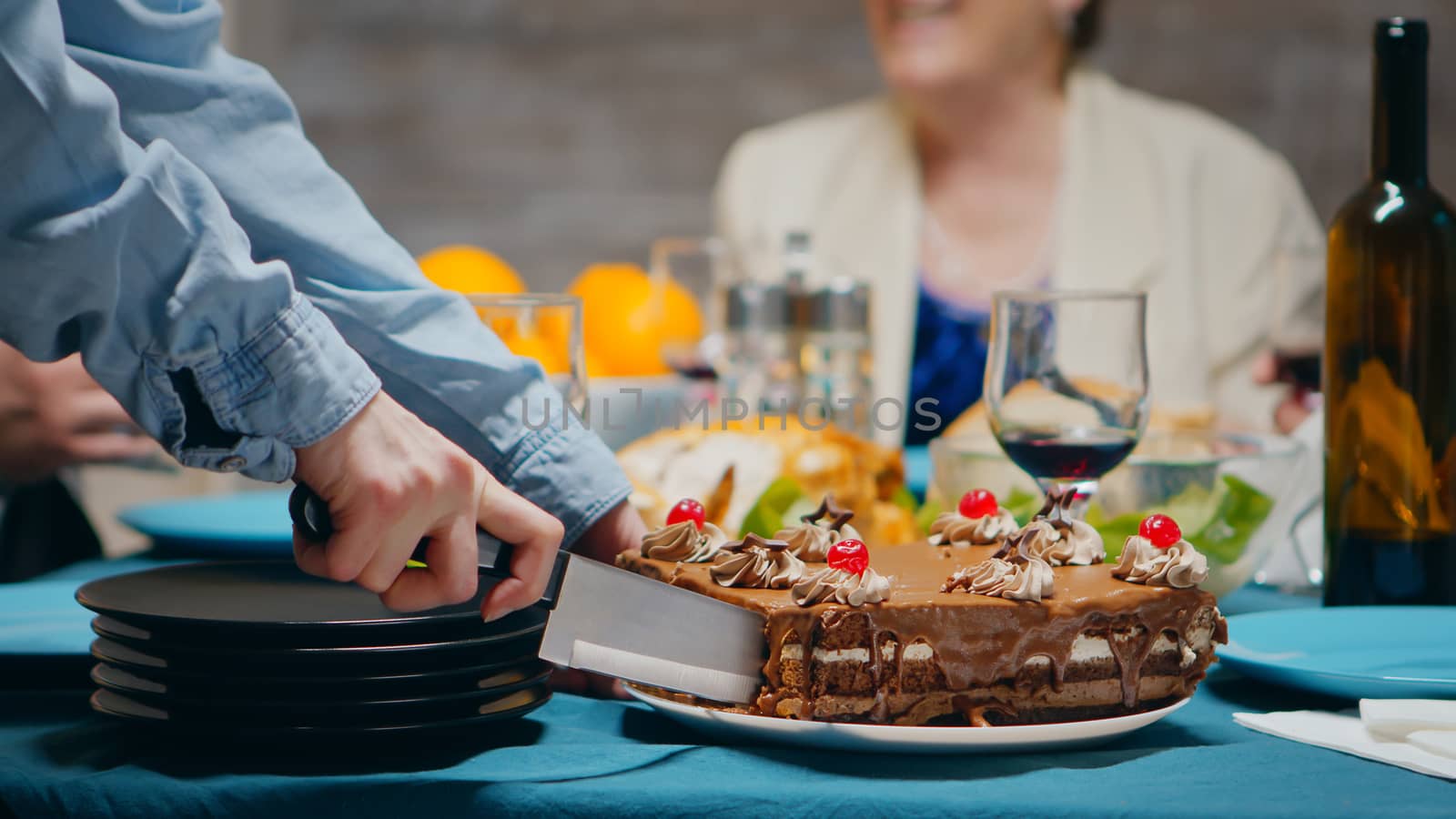 Close up of young woman slicing delicious cake by DCStudio