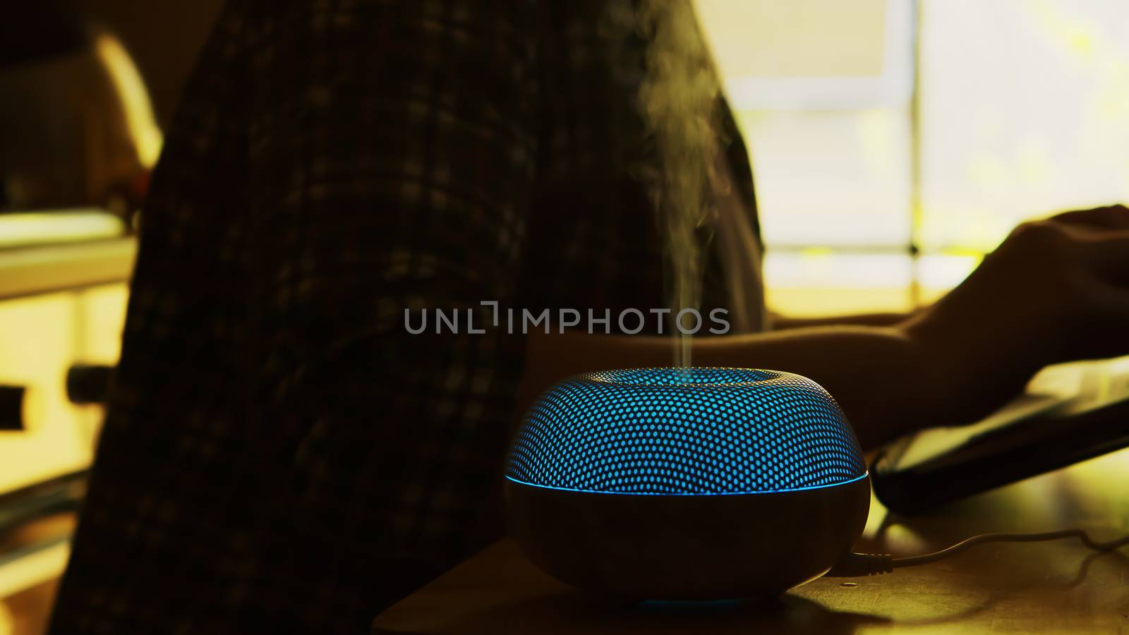 Silhouette of vapor with essential oils from diffuser in an apartment.