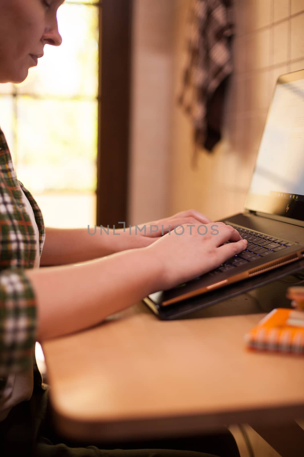 Businesswoman typing on laptop keyboard during covid-19 from home.