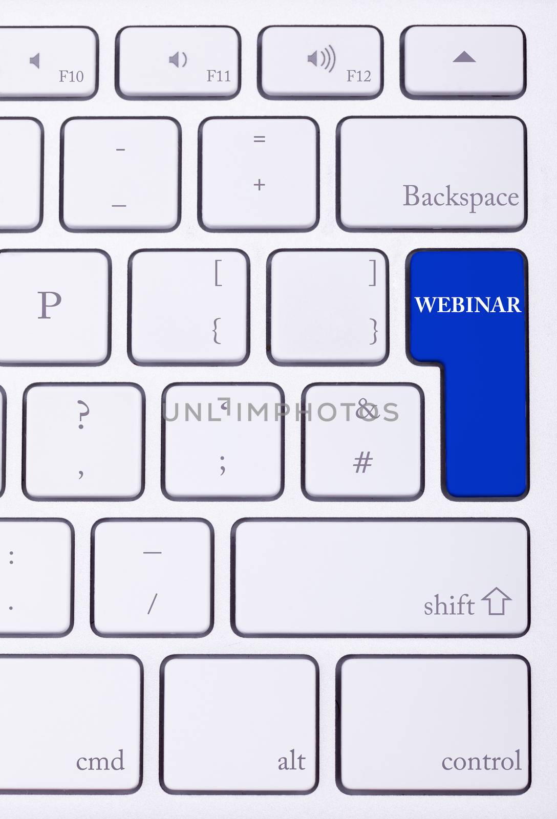 Keyboard with webinar text on blue button in close up