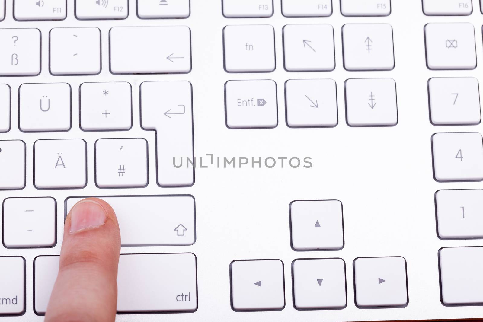 Finger pressing on keyboard key in close up