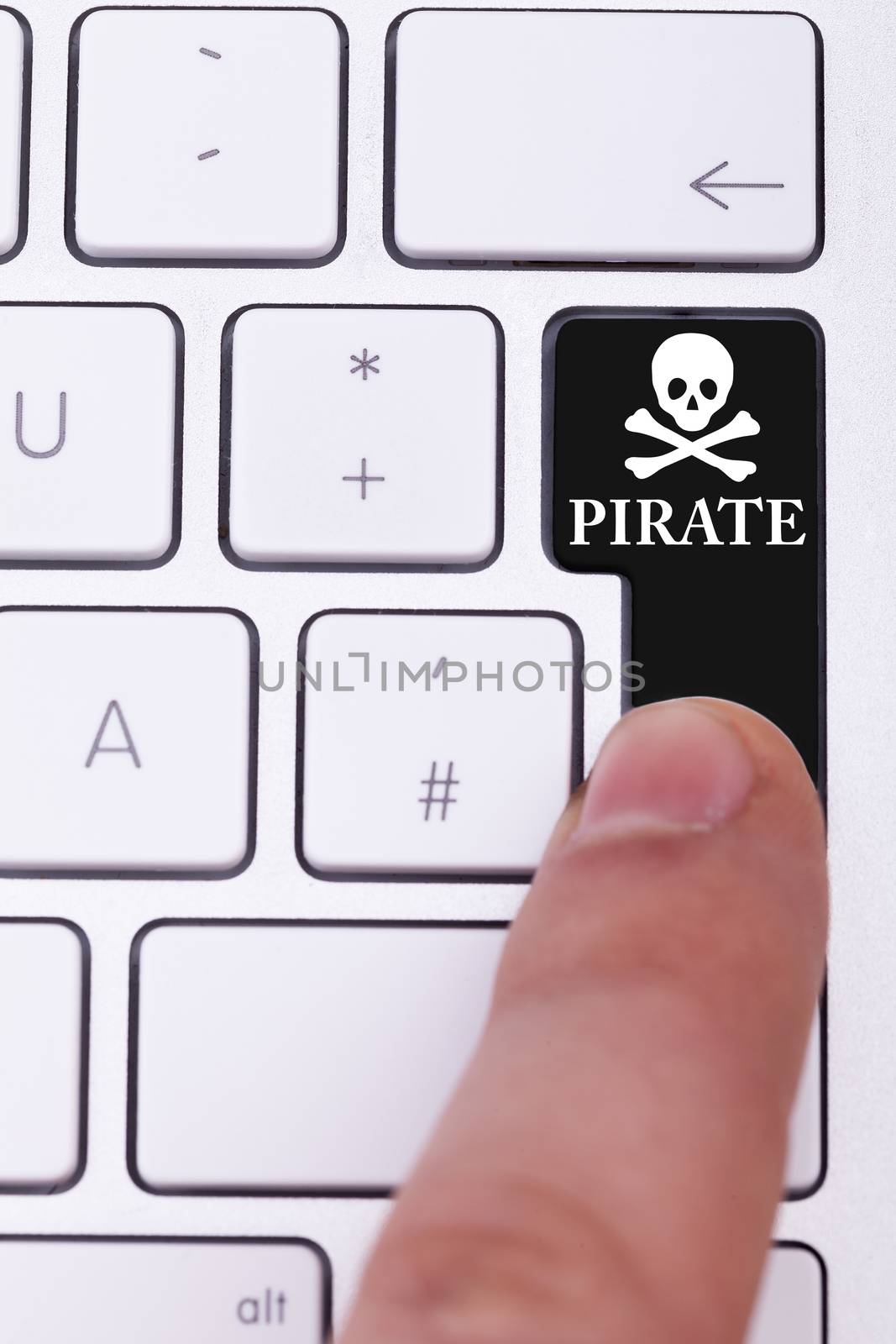 Finger pressing the pirate button and skull on keyboard. Illegall data transfer