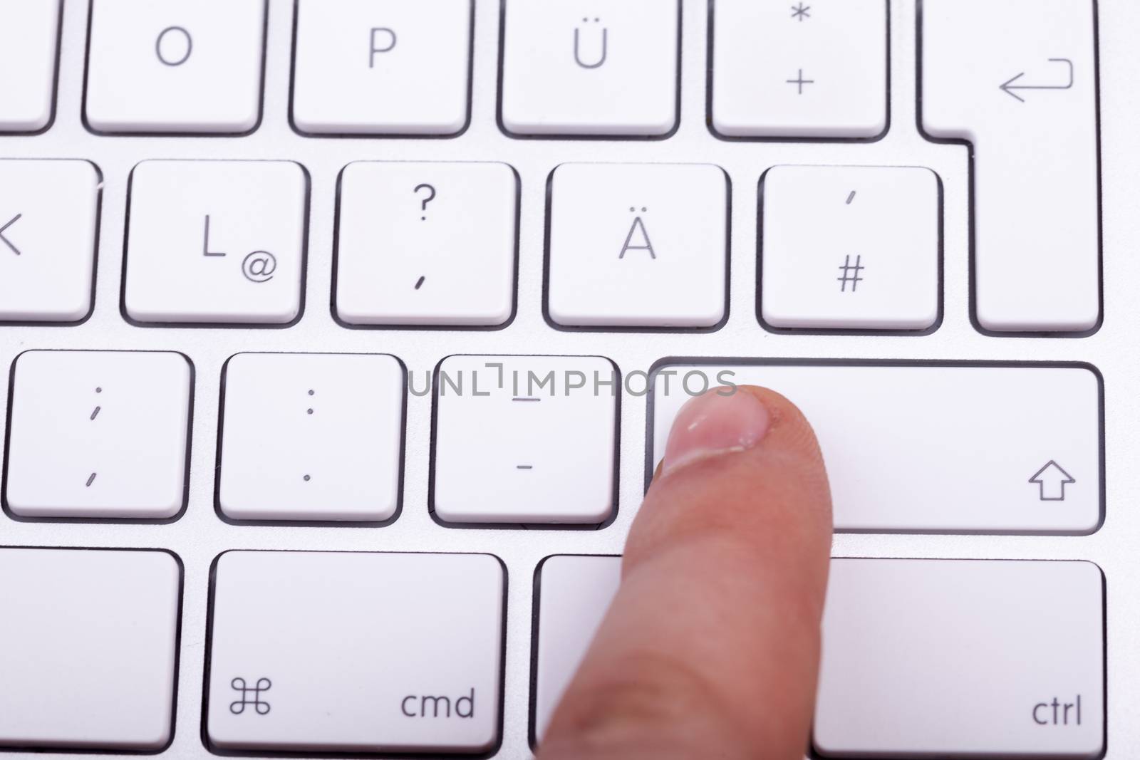 Finger pressing on keyboard key in close up