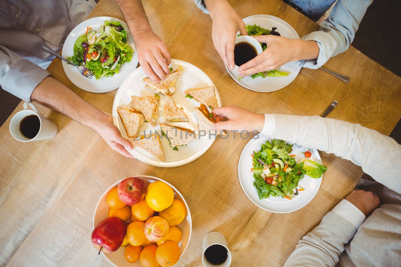 Business people having lunch in canteen by Wavebreakmedia