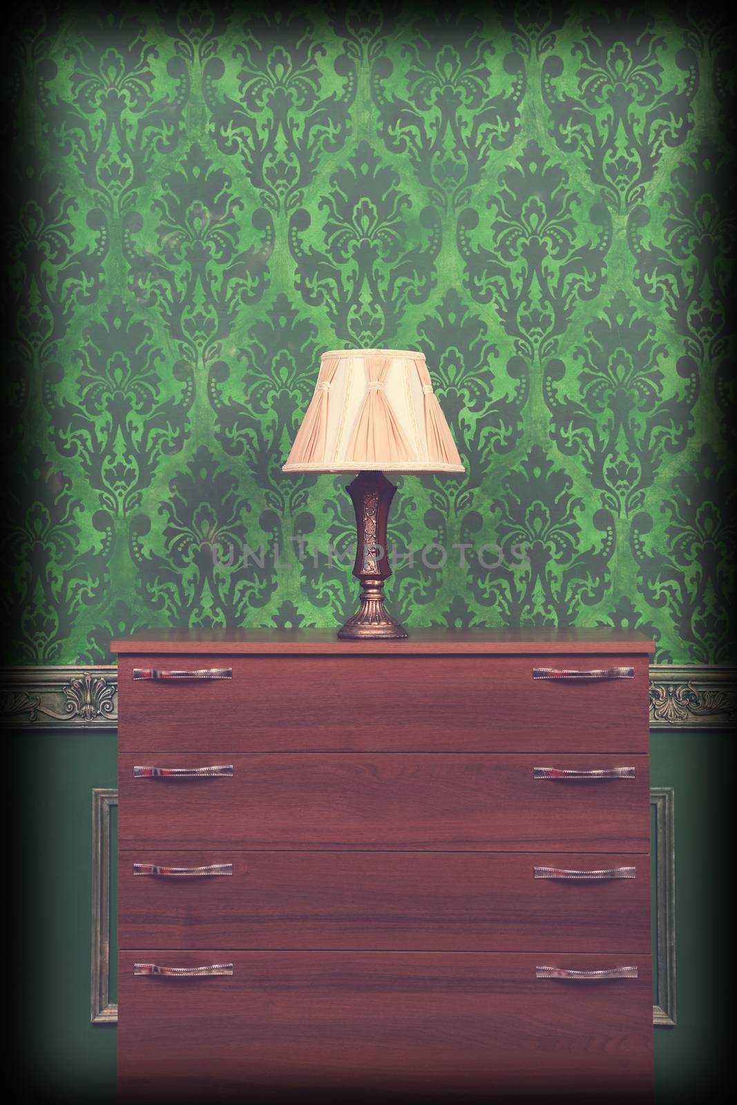 Lamp holder in green vintage interior with vignette. Rococo pattern. Old rich luxury interior