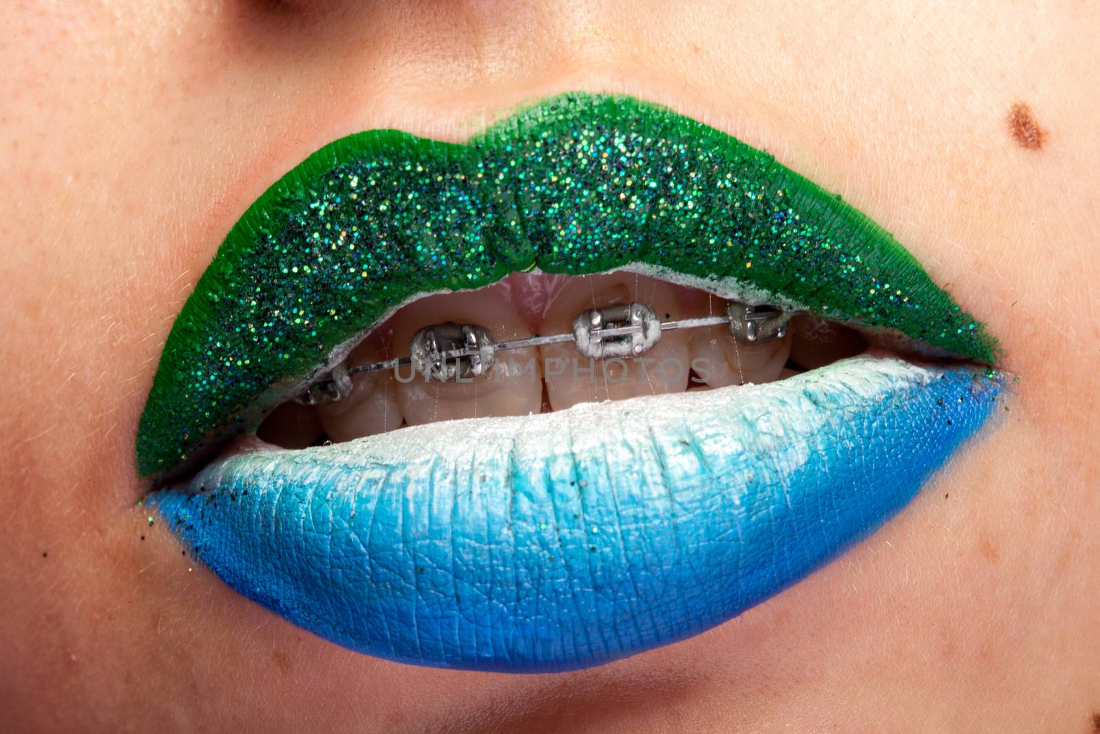 Beauty image of lips with artistic make up in studio photo