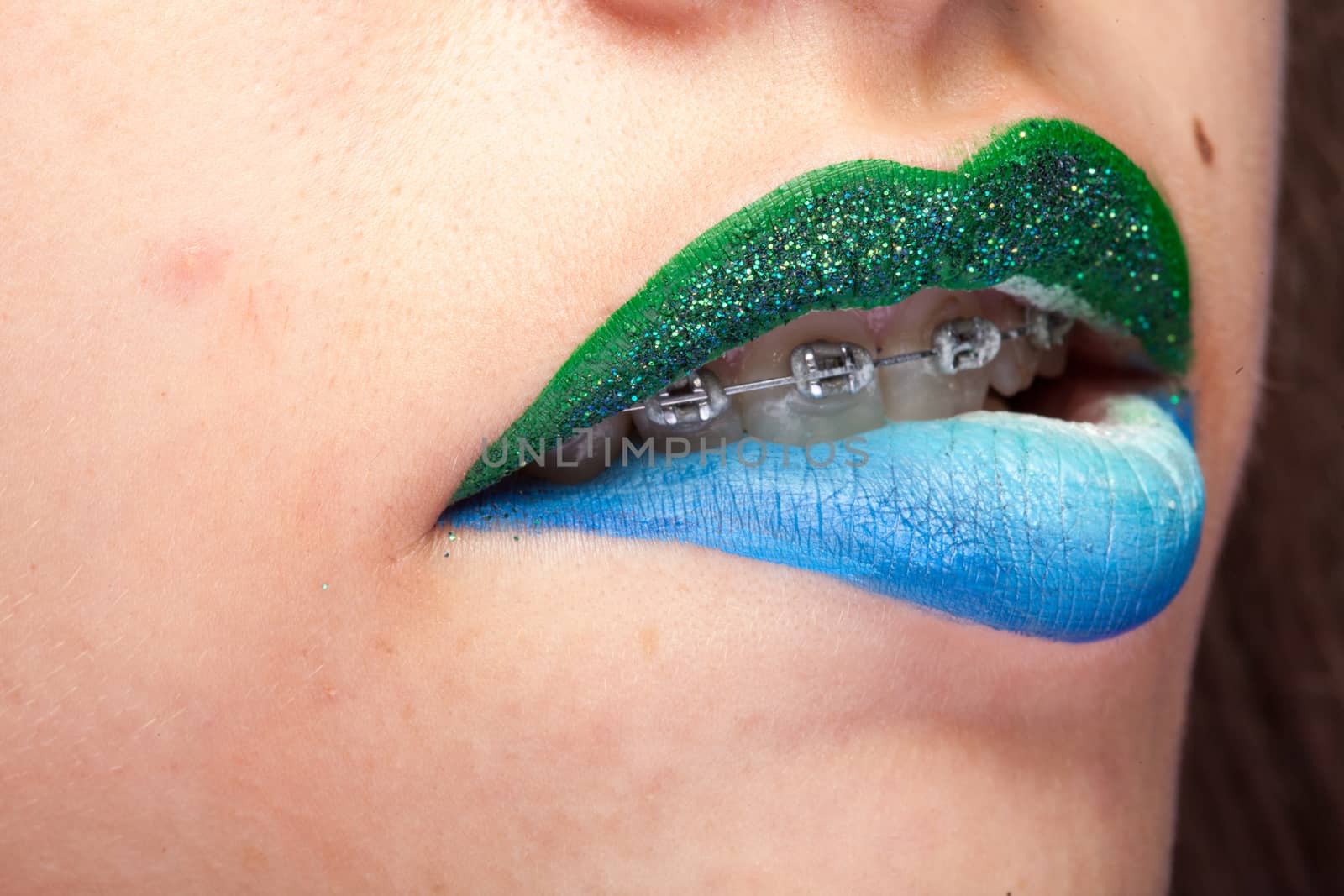 Beauty image of lips with artistic make up in studio photo