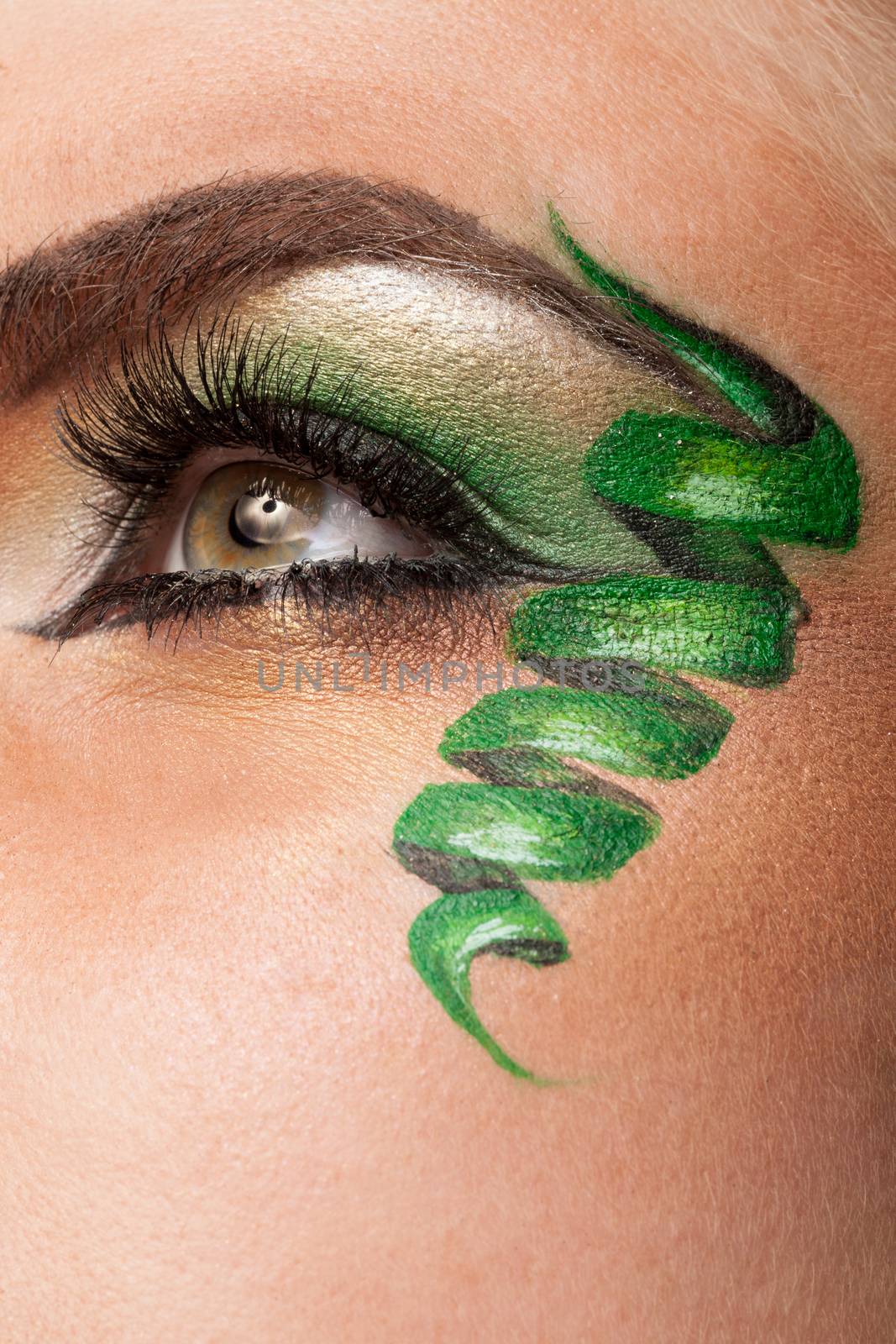 Eye with professional artistic green make up in studio photo