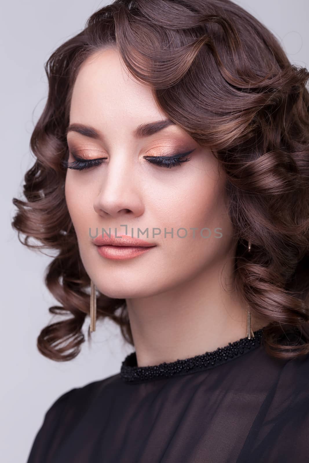 Sensual brunette professional make up eyes closed. Studio shooting