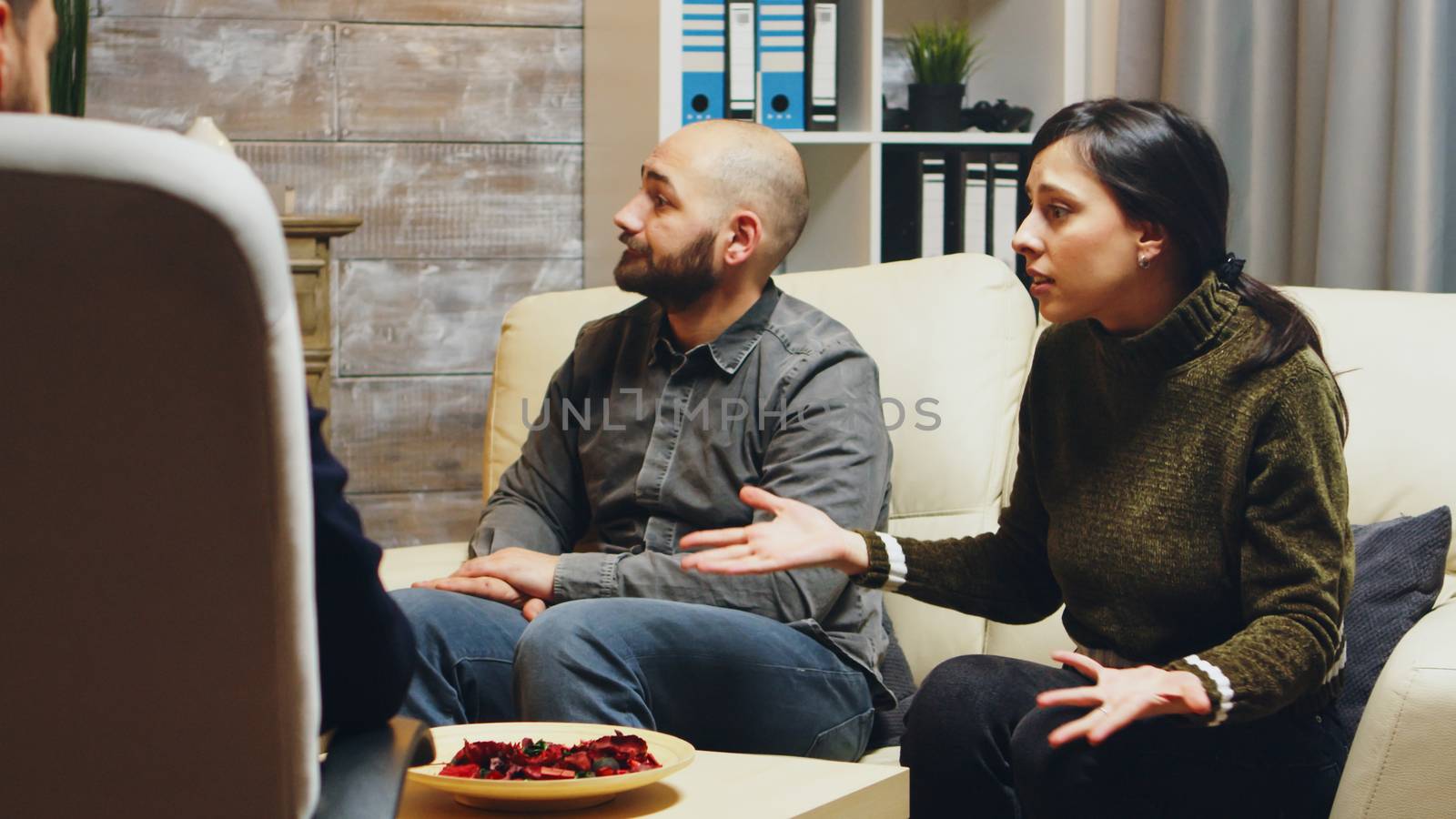 Zoom in shot of angry young wife at couples therapy. Psychologist in couple difficulties.