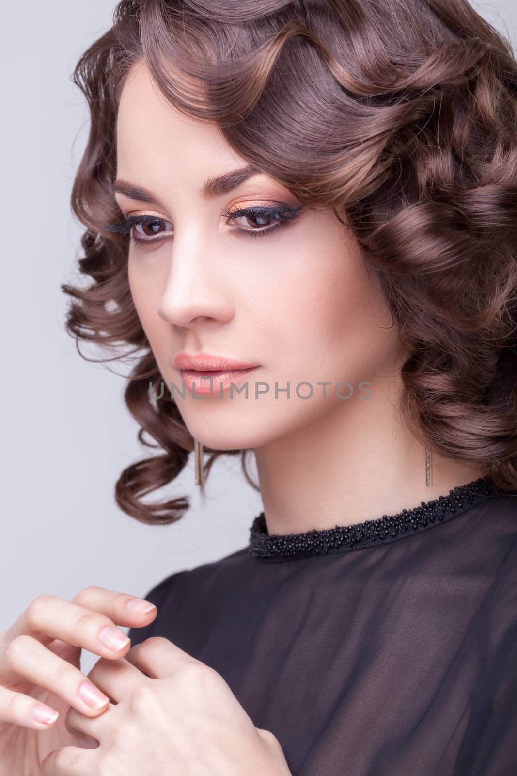 Sensual woman professional make up on grey background studio shooting. Elegant hairstyle. Clean skin with texture