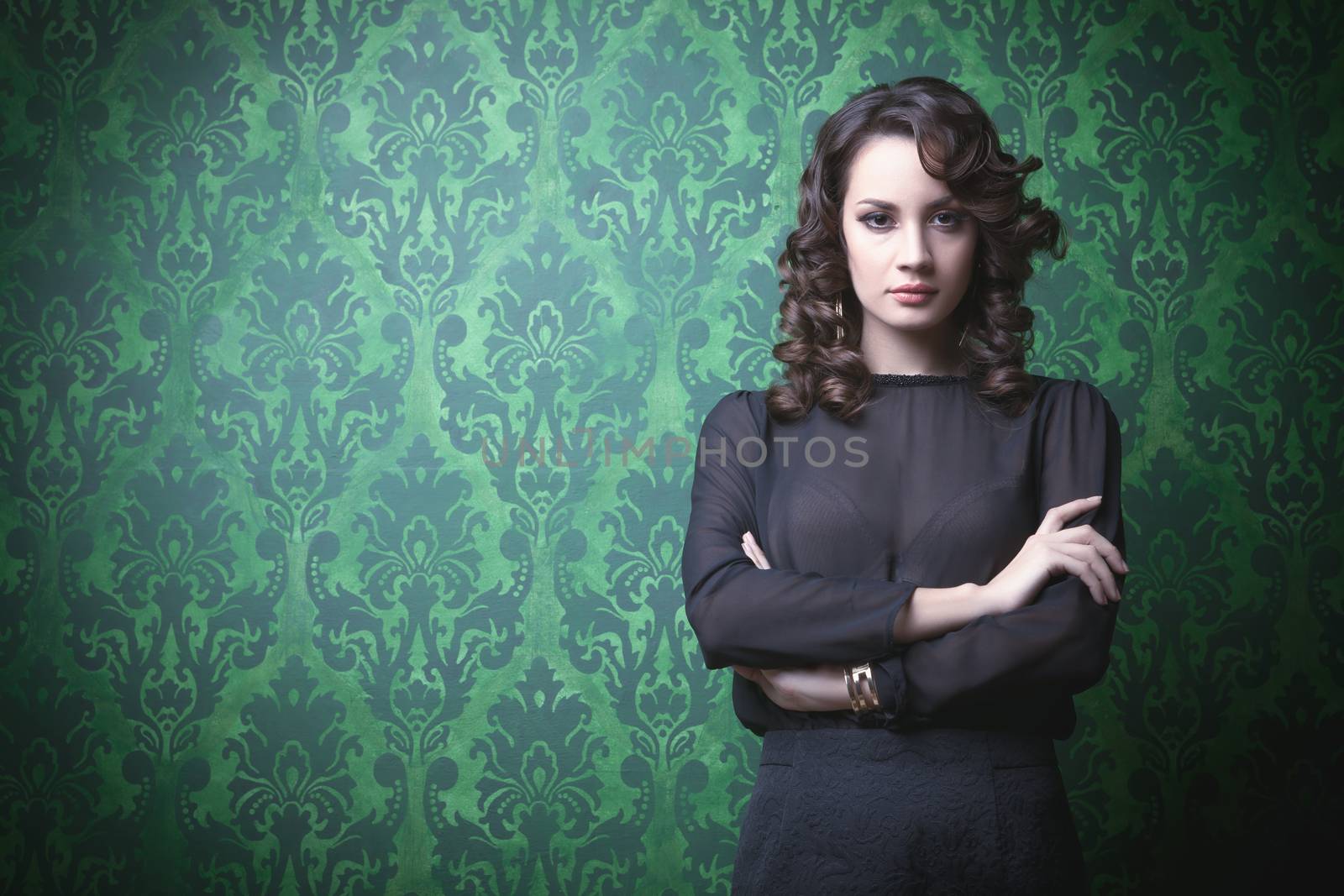 Beautiful woman in green vintage room. Professional make up and hairstyle. Retro rich interior. Toned image
