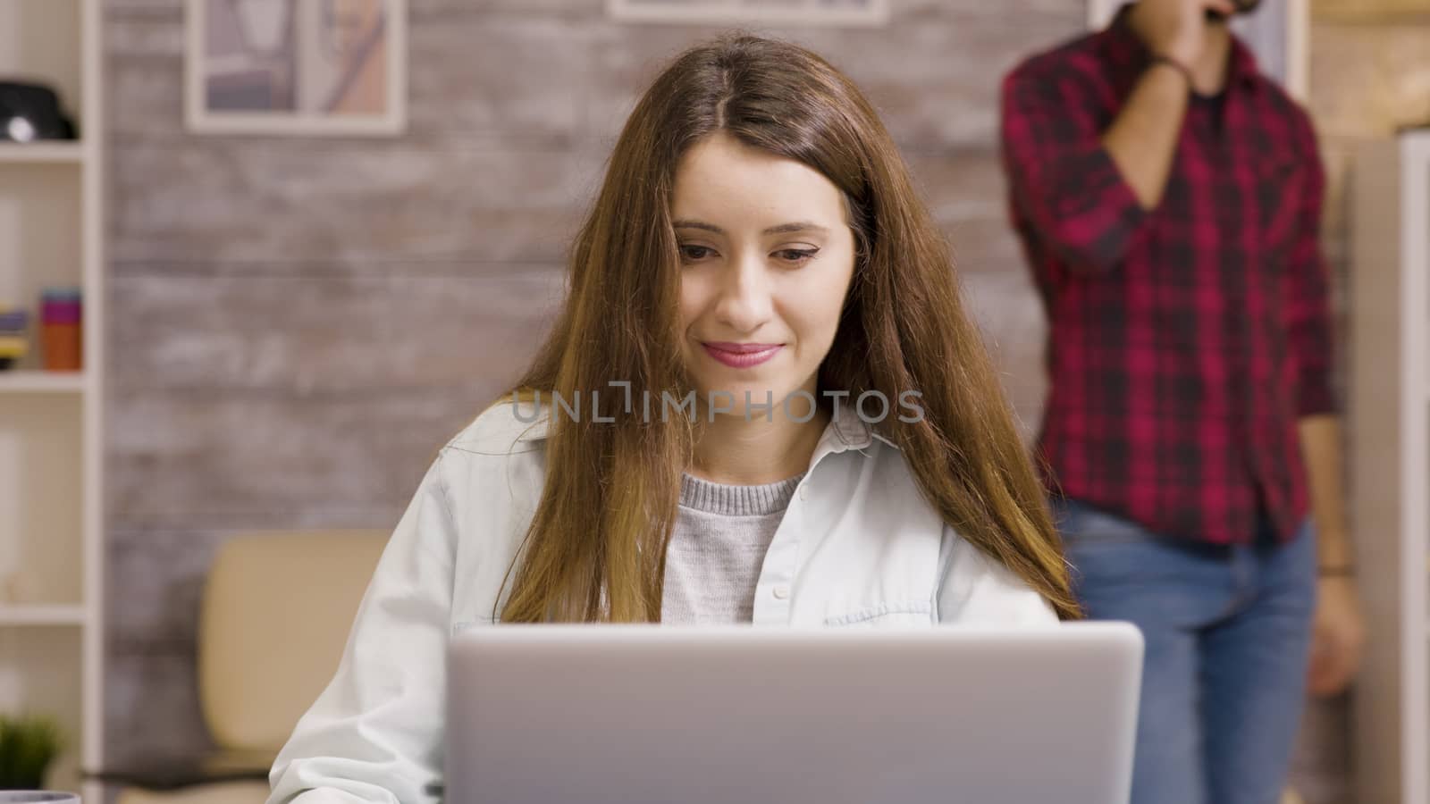 Girl enjoying a cup of coffee while working from home by DCStudio