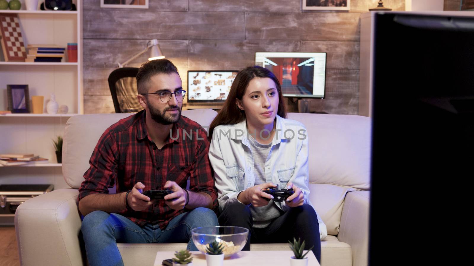 Couple giving high five after playing video games on television.