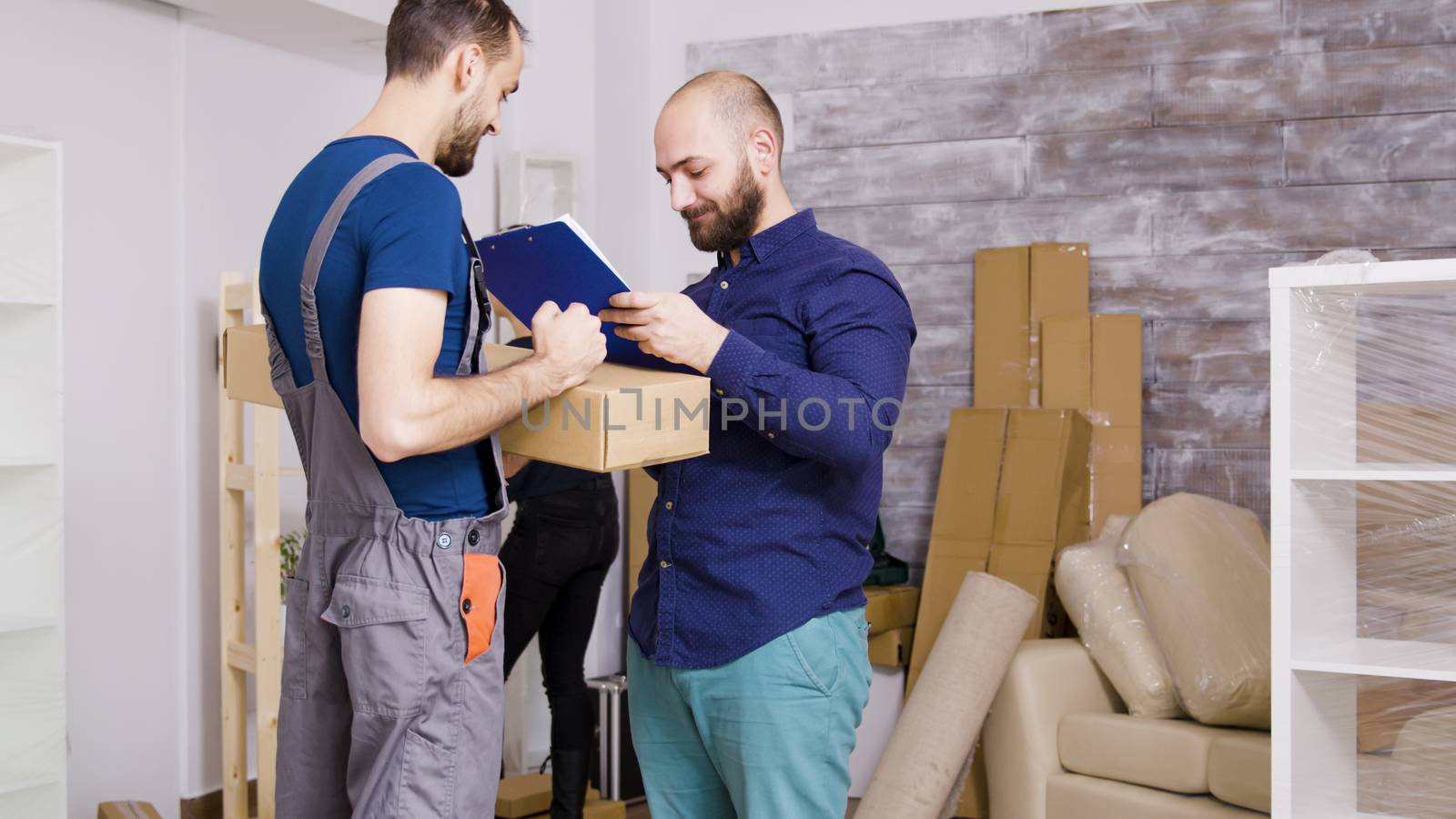 Man from delivery service arriving with boxes and documents to be signed by DCStudio