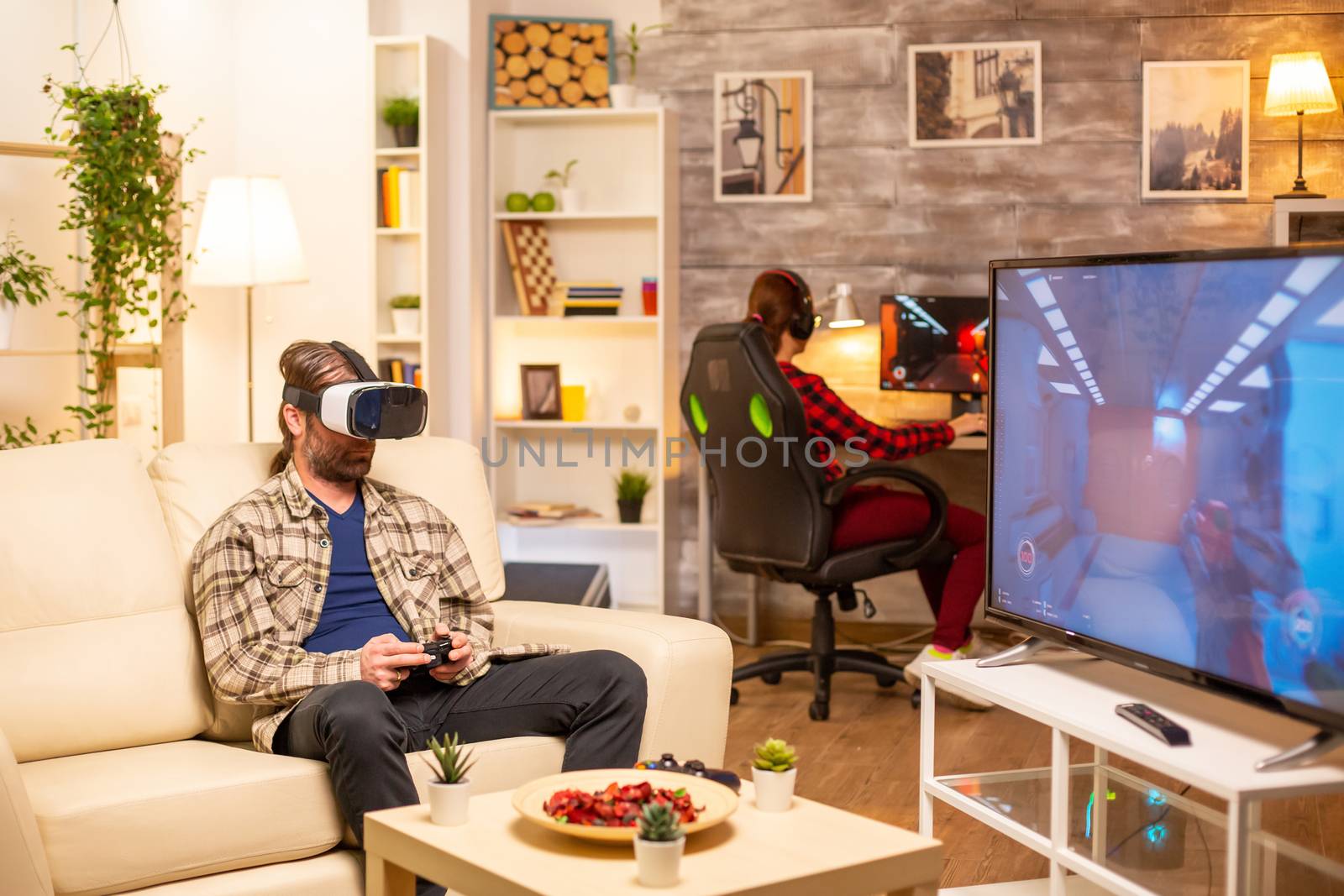 Man gamer using a VR headset to play video games in the living room late at night