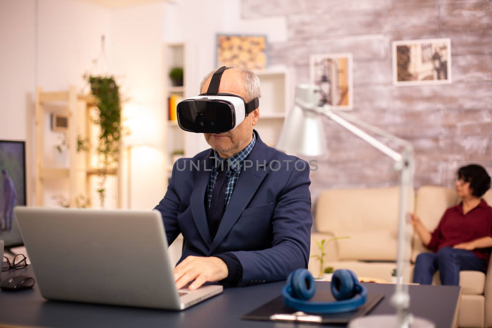 Elderly man experiencing new virtual reality technology for the first time in his home