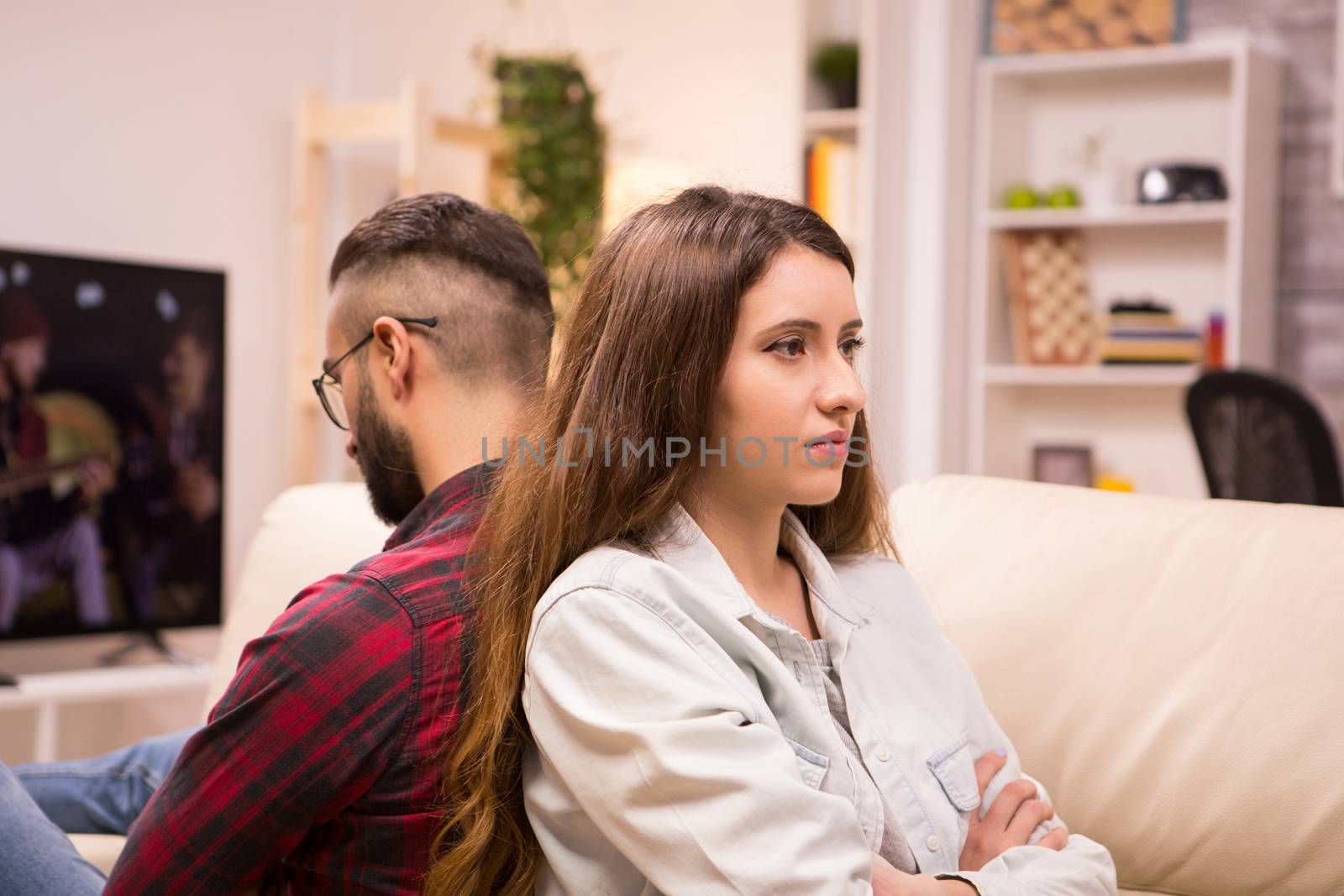 Caucasian couple sitting back to back with serious relationship problems. Unhappy couple.