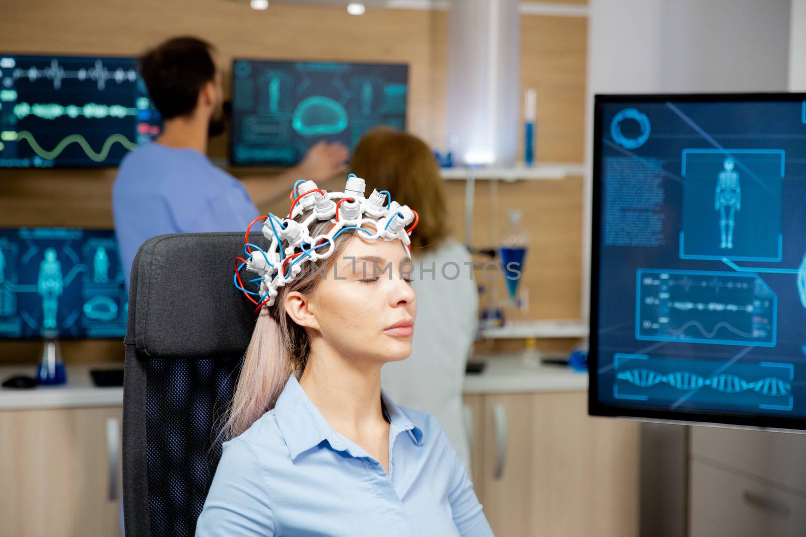 Female patient scanning her brain with neurology headset by DCStudio