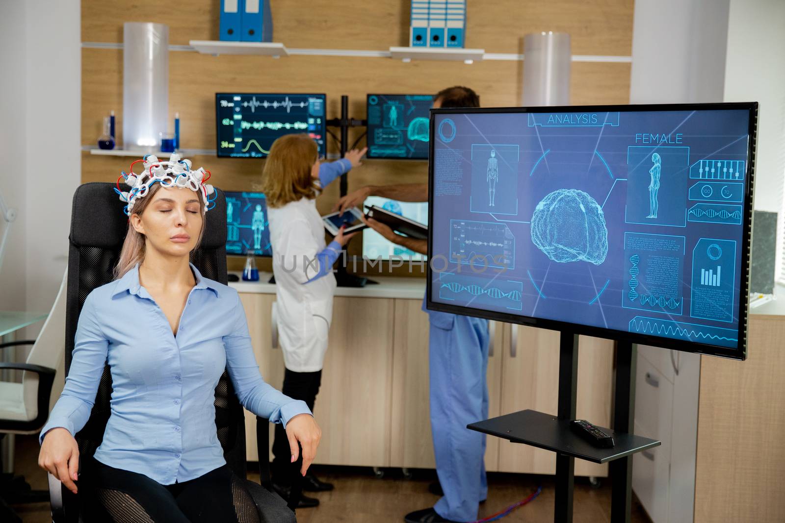 Patient who is brain scanned and his activity is seen on the big screen. Neurology headset