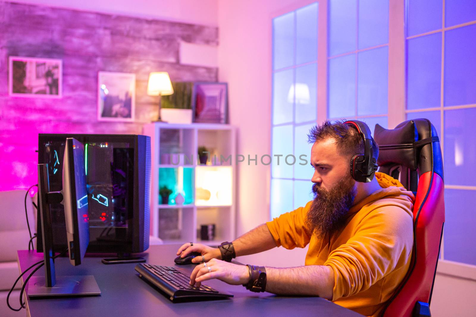 Professional EA sport gamer playing on powerful PC by DCStudio