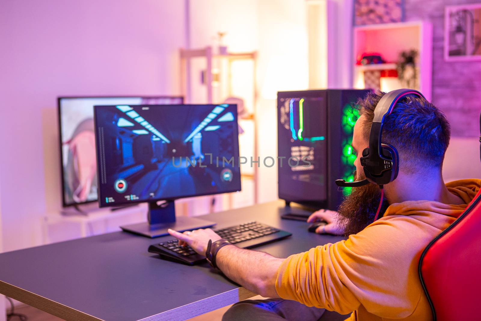 Hipster man playing professional video games in his room by DCStudio