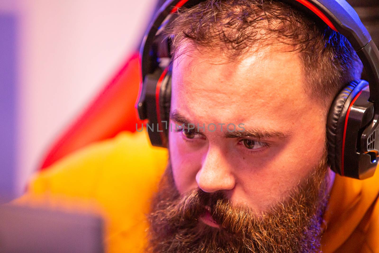 Close up portrait of professional bearded video gamer in front of his PC