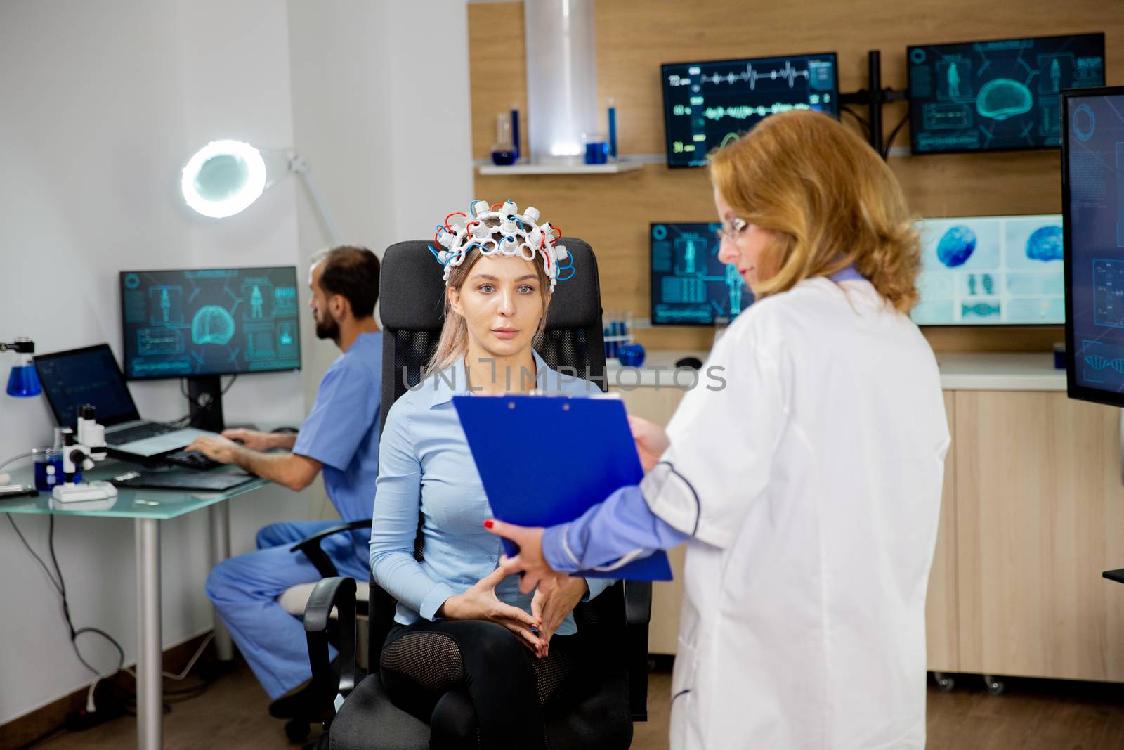 Patient woman scanning her brain and looking at a clipboard holding the doctor in her hand