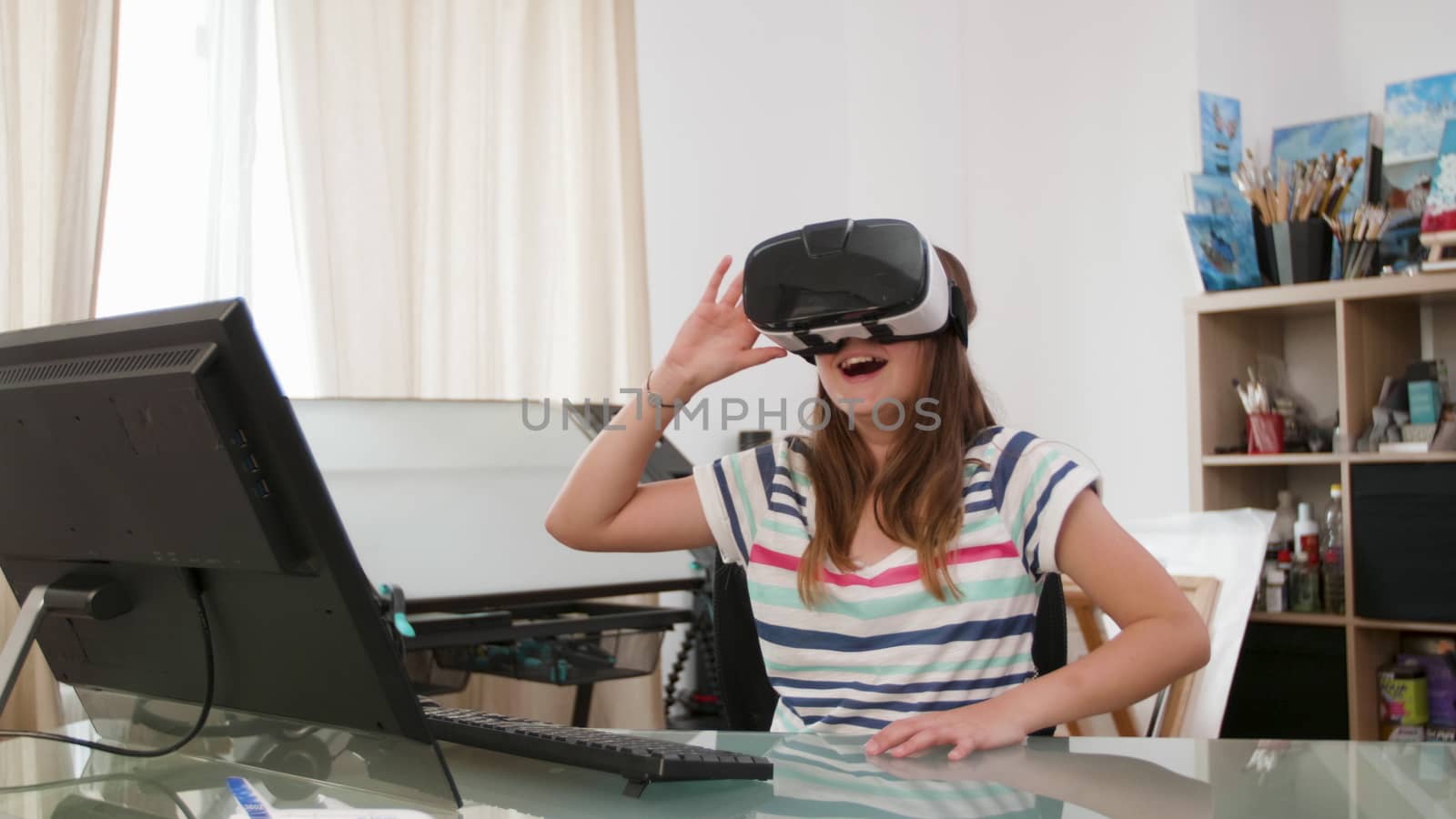 Teenage girl with a virtual reality headset making different gestures with her hands. Futuristic educational process.