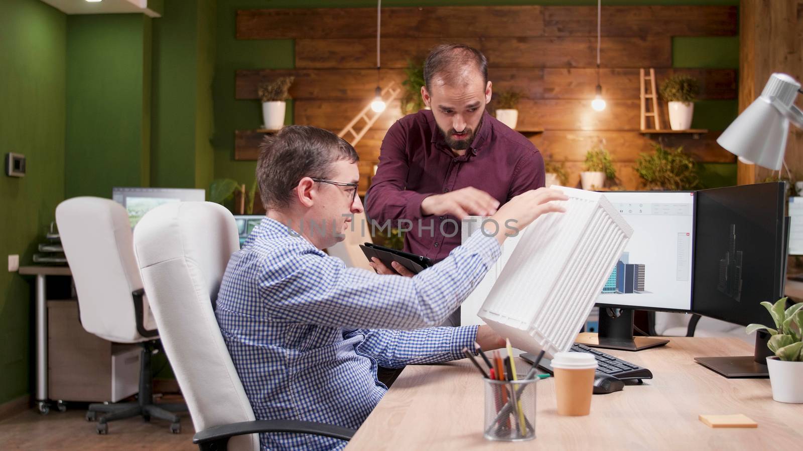 Team of architects in the office having a conversation about the structure of a new building.