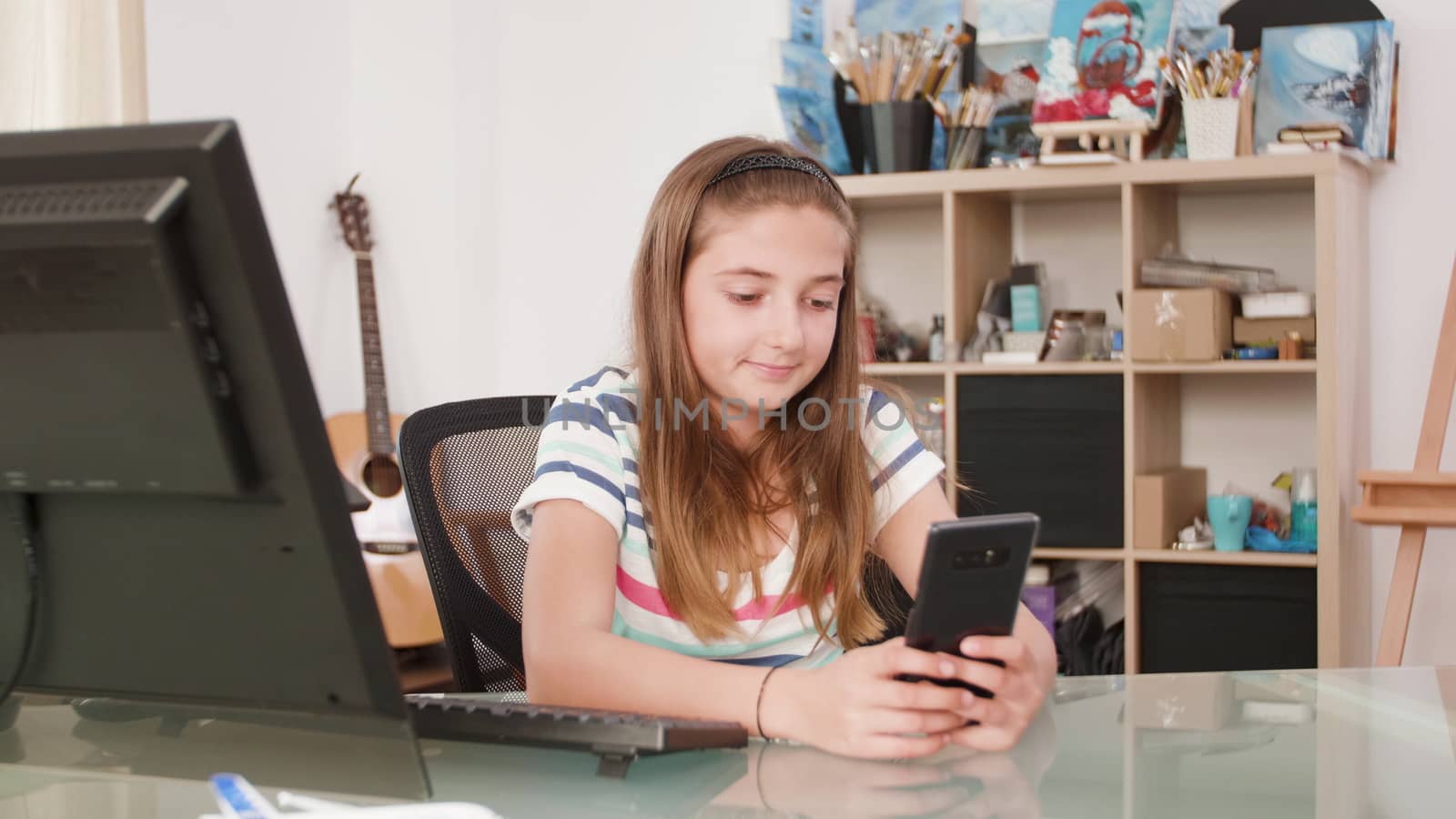 Teenage girl chating on video call with her friends. Cozy artsy room in the background