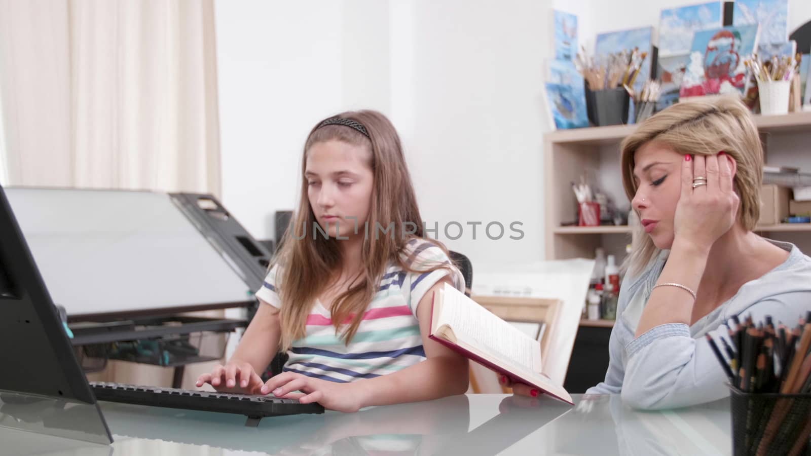 Mother dictates a text from a book to her daughter. Teenage girl writes a text from a book that her mother reads.