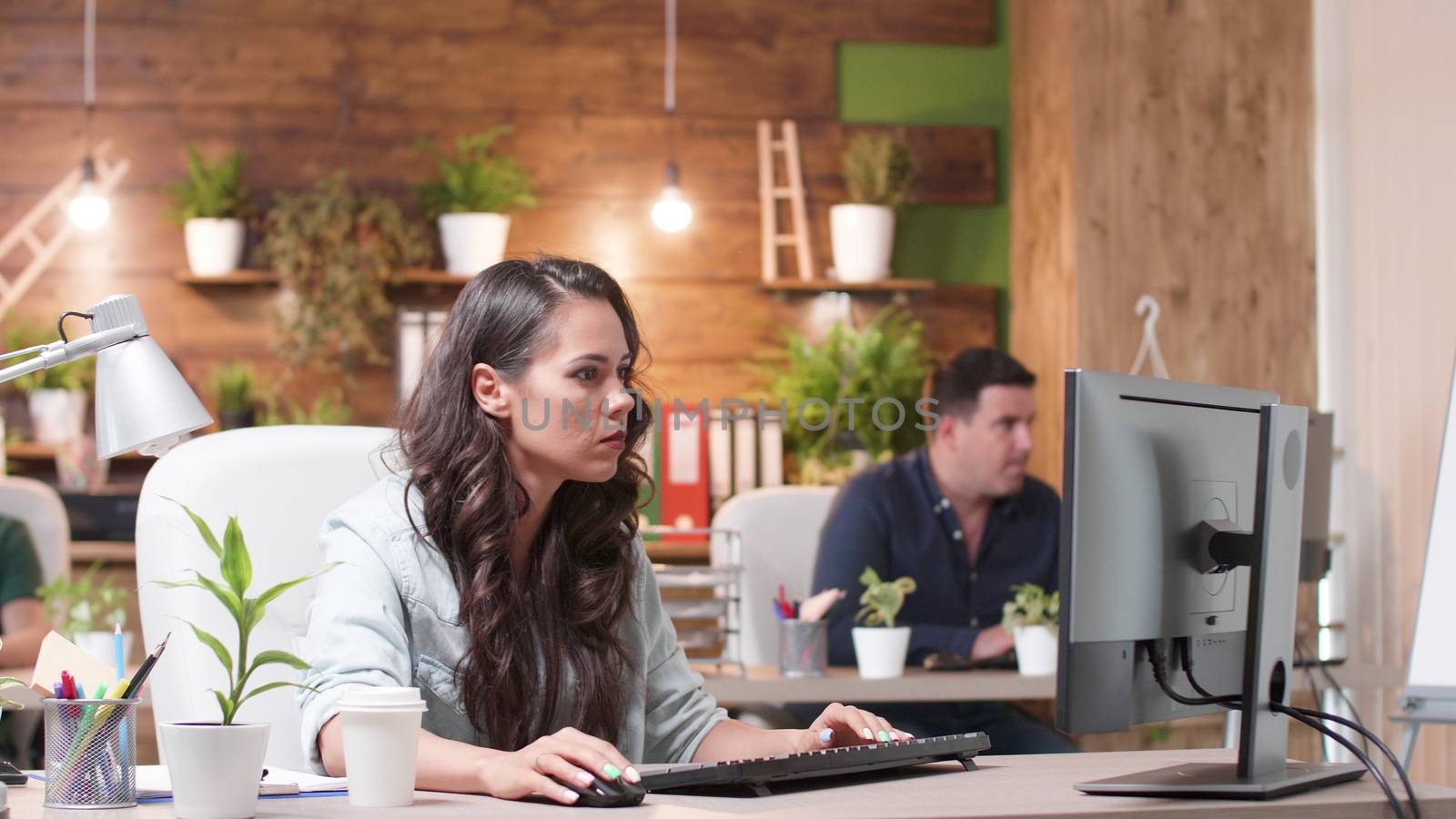 Female and male colleagues talking over a new project. They are working in a cozy office. Marketing team