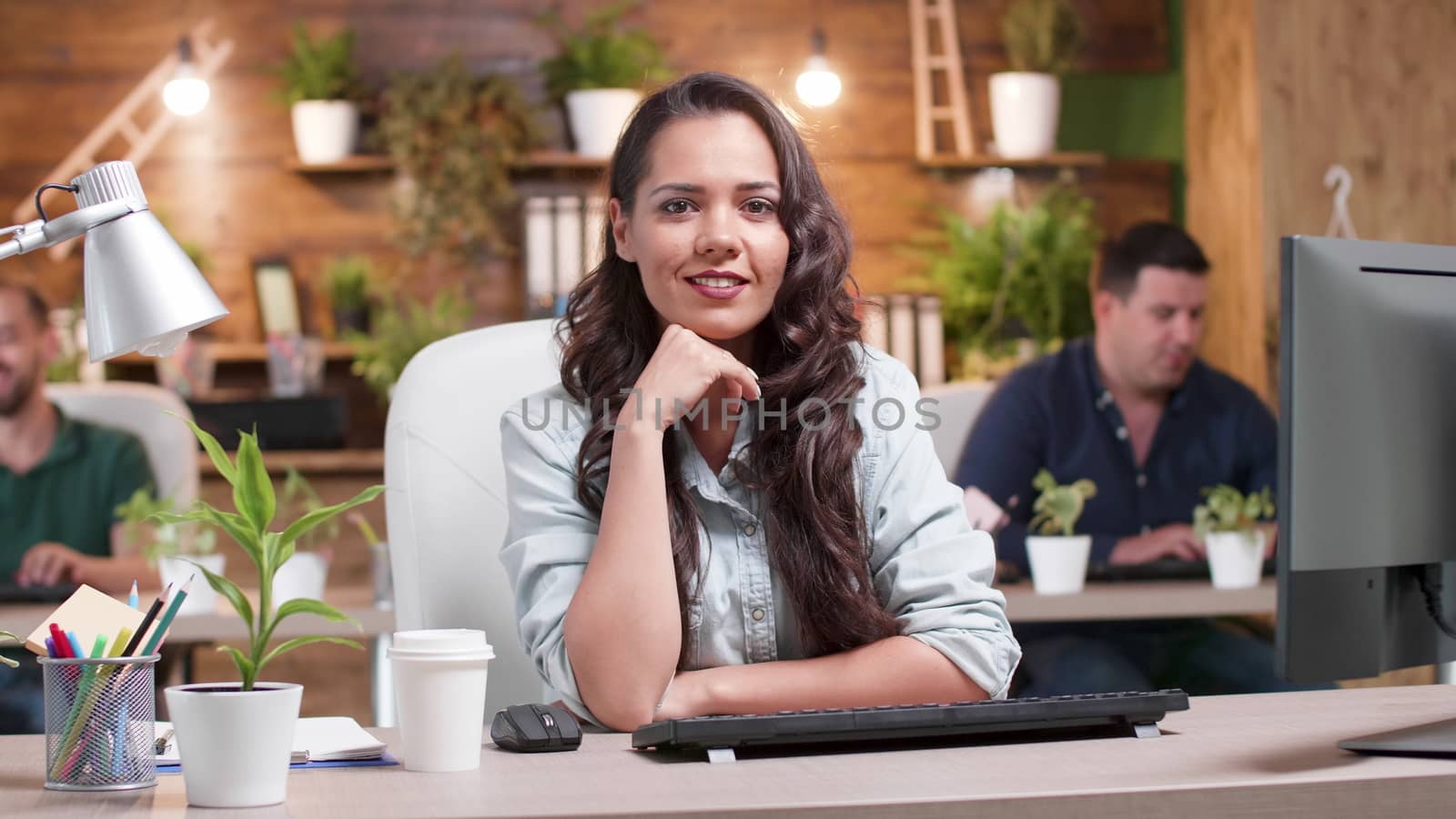 Portrait of woman smiling to the camera in an office environment