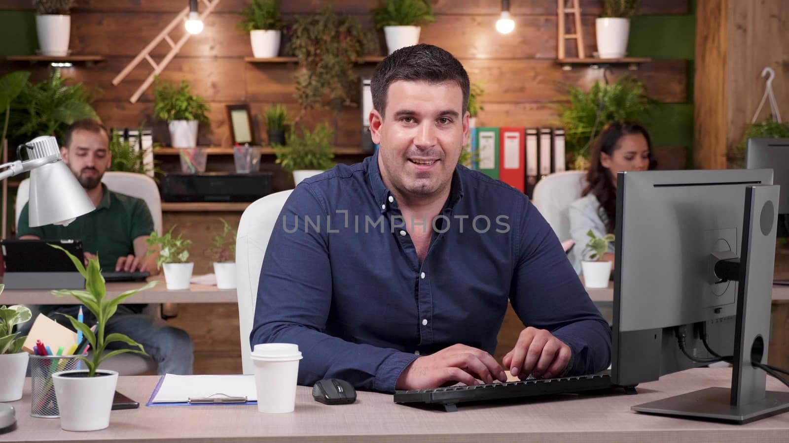 Portrait of smiling office worker in casual clothes. Zoom in slow motion shot