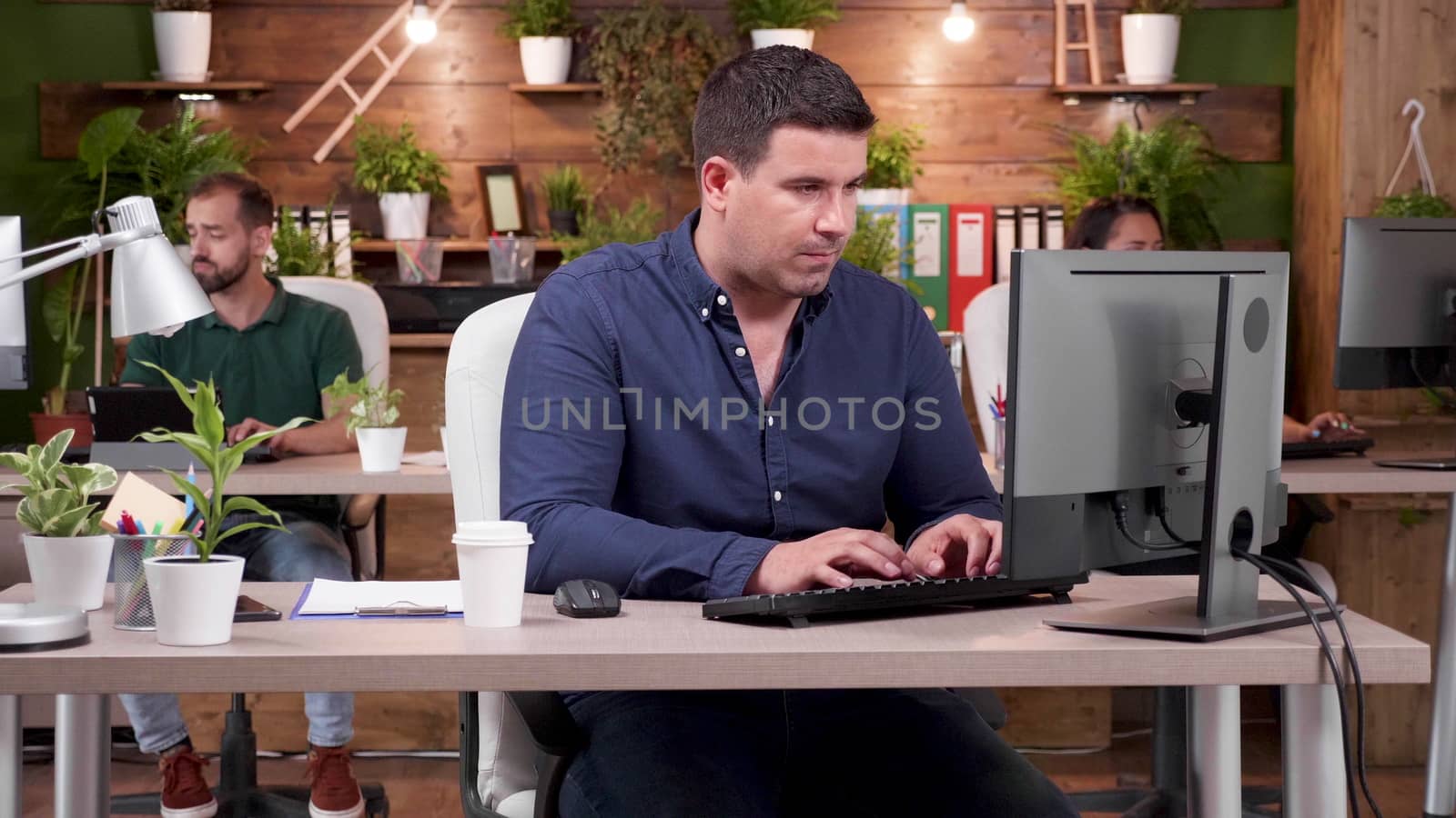 Working concentrated on the computer. Zoom in slow motion shot