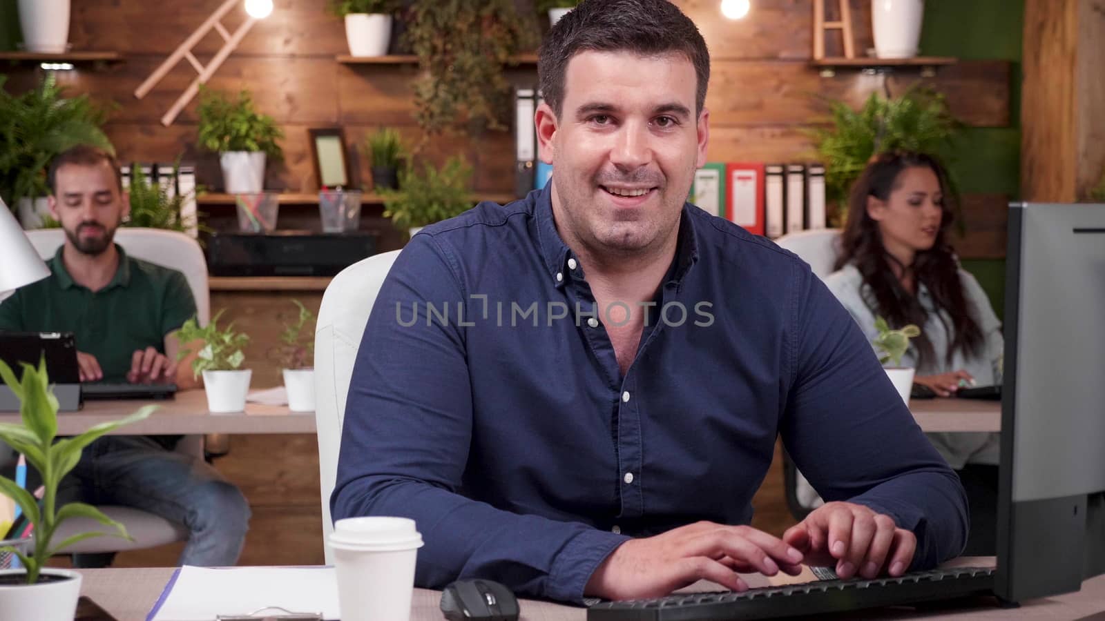 Close up shot of office worker smiling to the camera. Zoom in slow motion shot