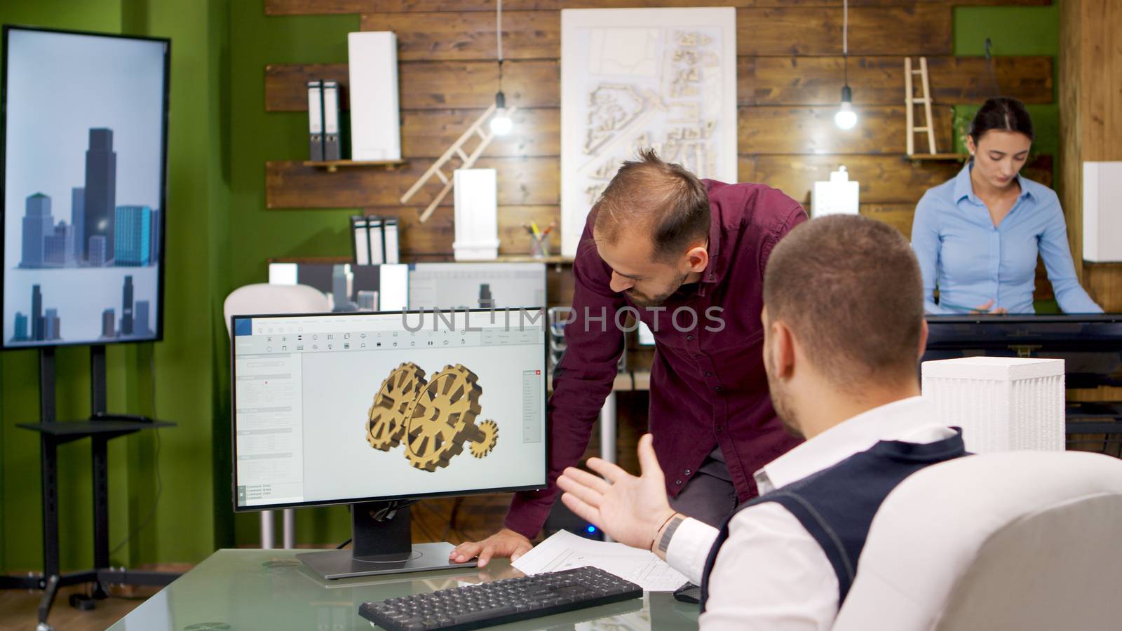 Team of creative architects working on computer. Architect having a discussion.