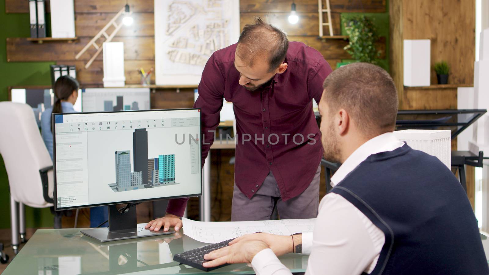 Team of architects working on the architectural structure in building models on computer. Architects team work.